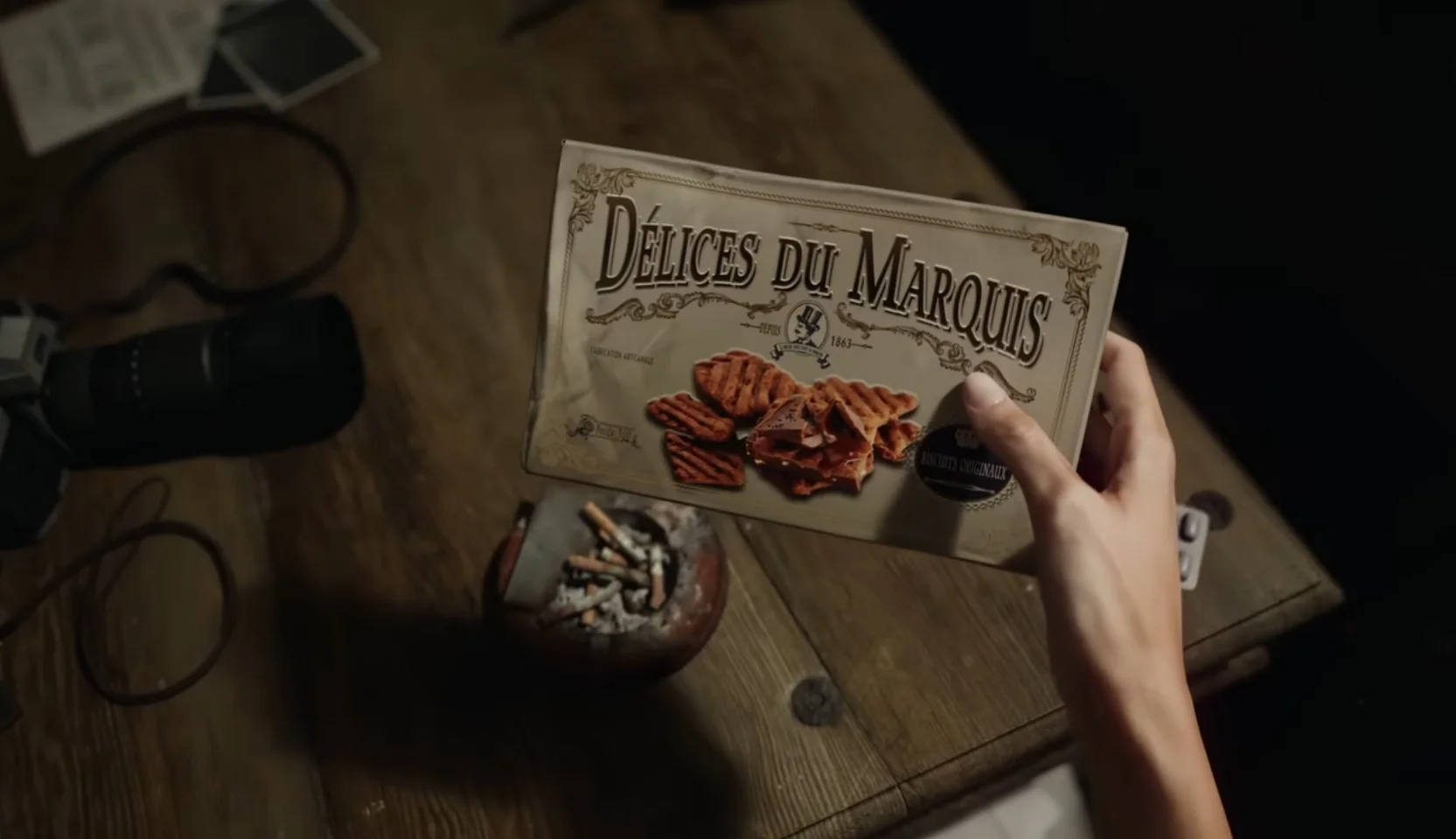 A first-person view shows someone holding a box of biscuits in the Resident Evil Veronica reveal trailer.