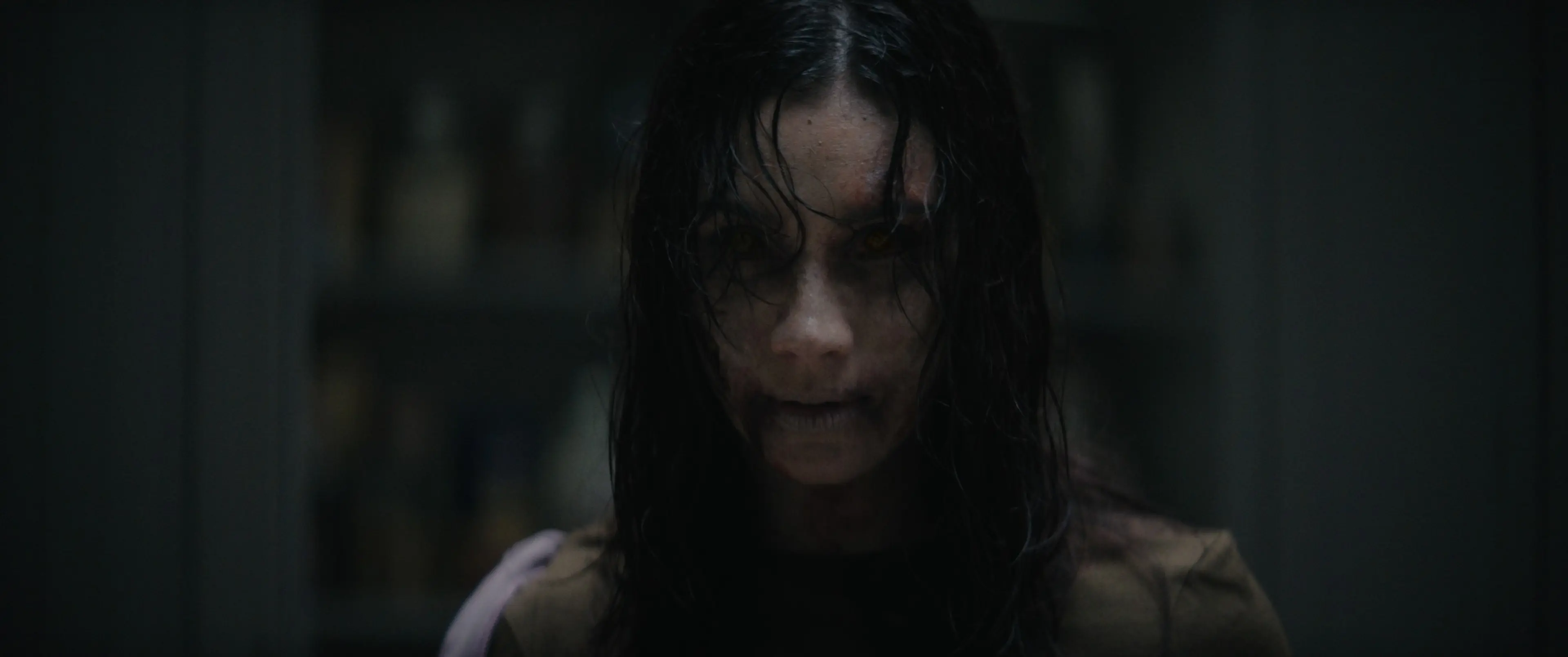 Luciane Buchanan as Thya stares ahead with dark eyes and wet hair.