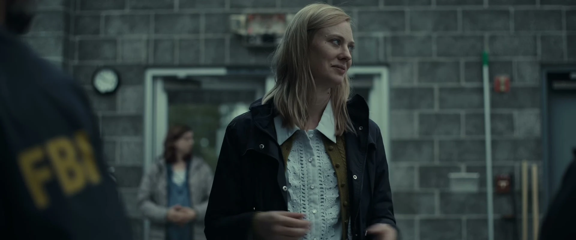 Deborah Ann Woll stands by an FBI investigator in an official The Cycle trailer frame.