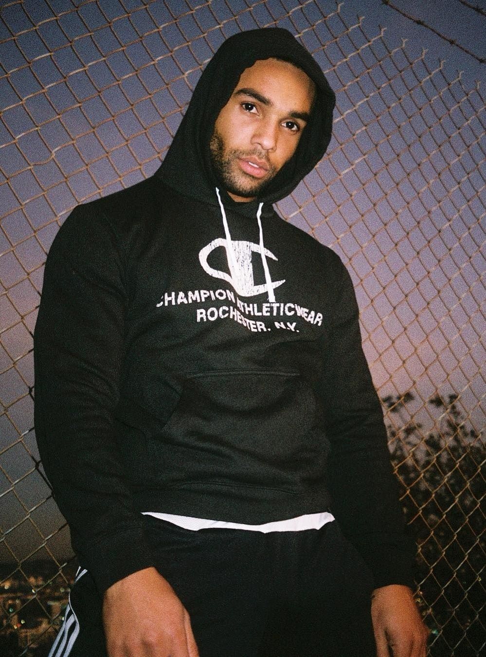 Lucien Laviscount in a black hoodie in a 2019 portrait.