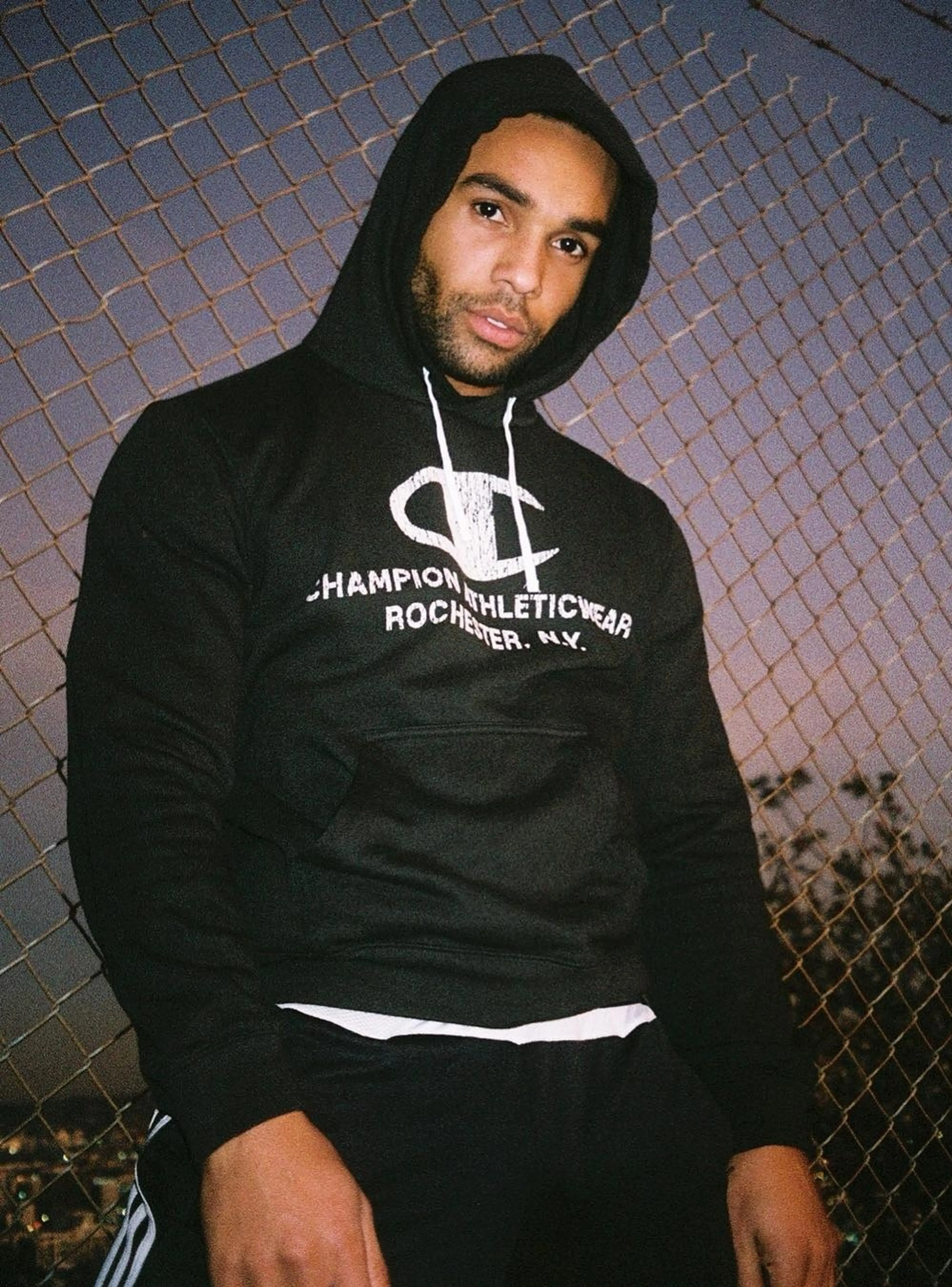 Lucien Laviscount in a black hoodie in a 2019 portrait.