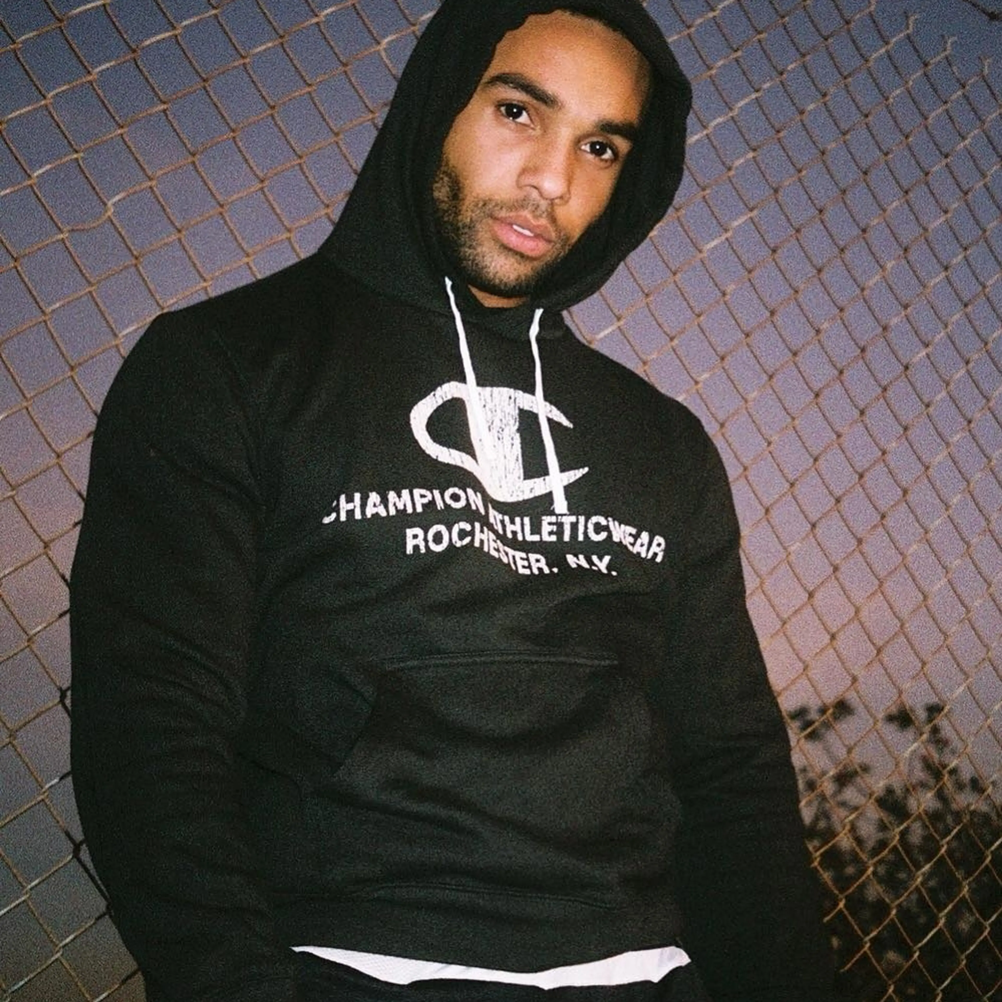 Lucien Laviscount in a black hoodie in a 2019 portrait.