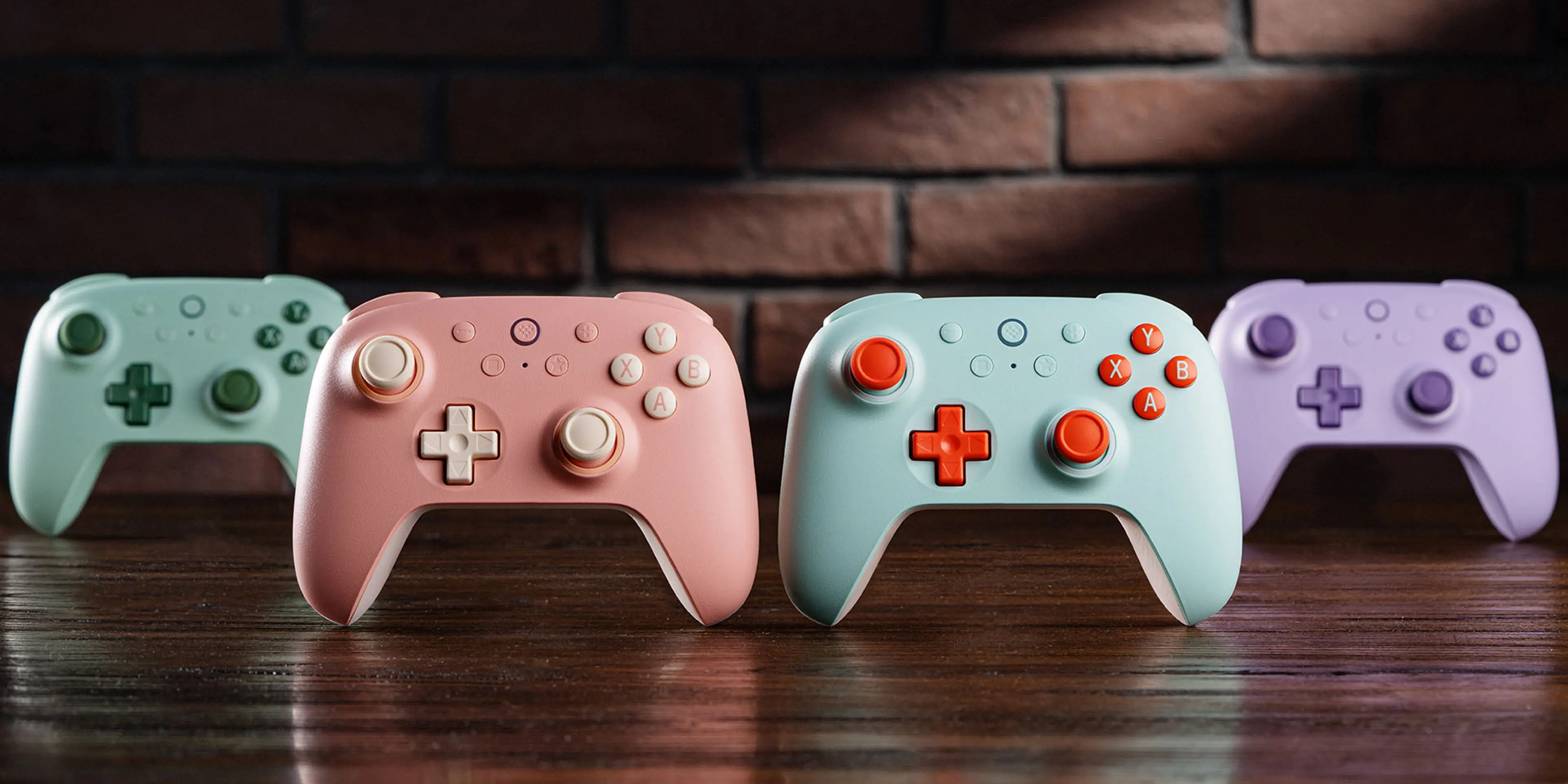 Green, Peach, Mint and Purple Ultimate 2C Wireless controllers lined up on a desk