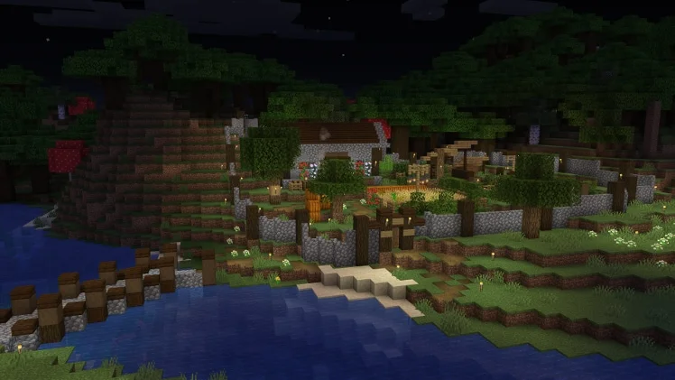 A Minecraft survival base lit at night with water, fencing, trees, and warm lights.