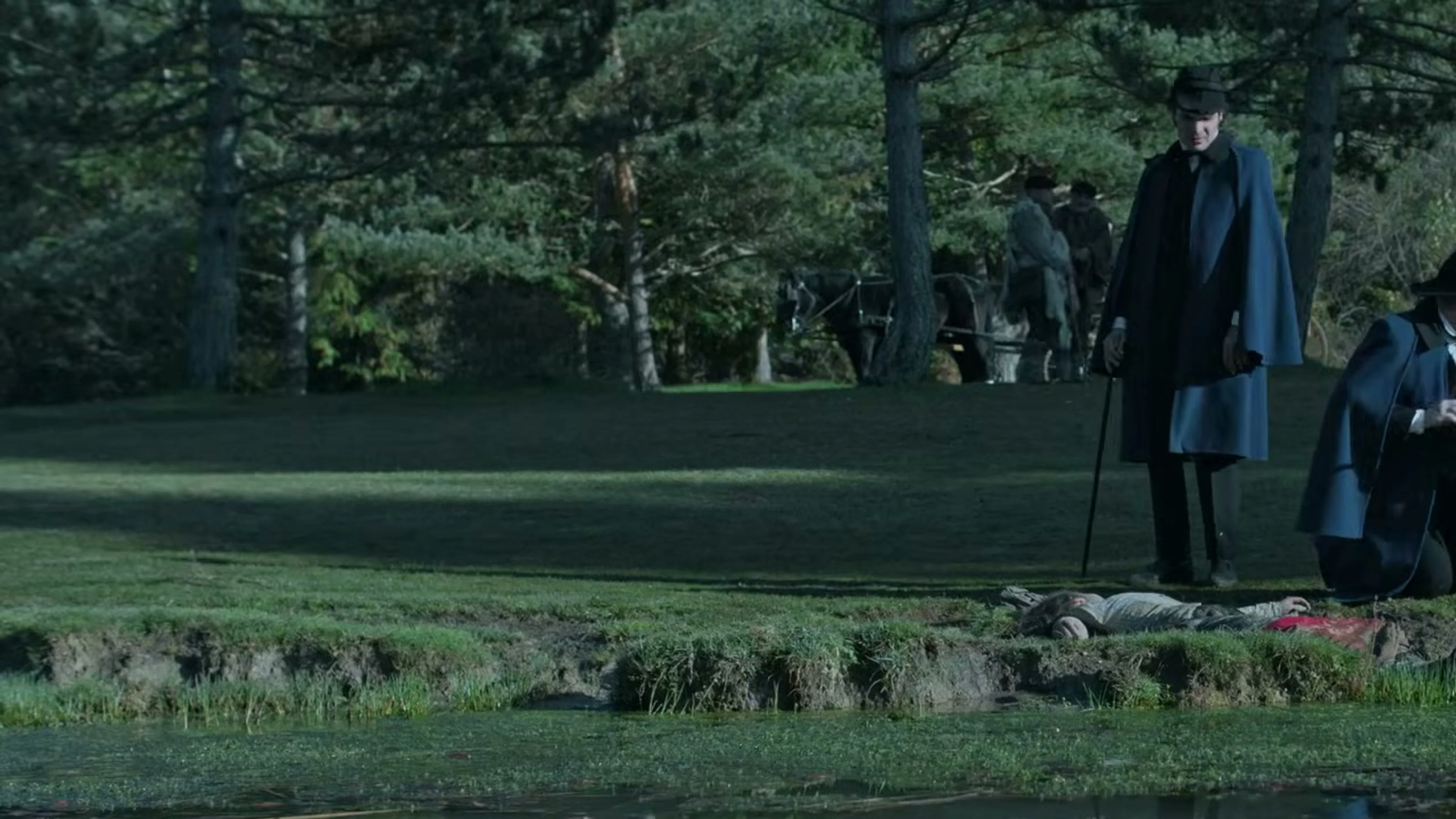 Mourners walk through a cemetery in The Harvester.