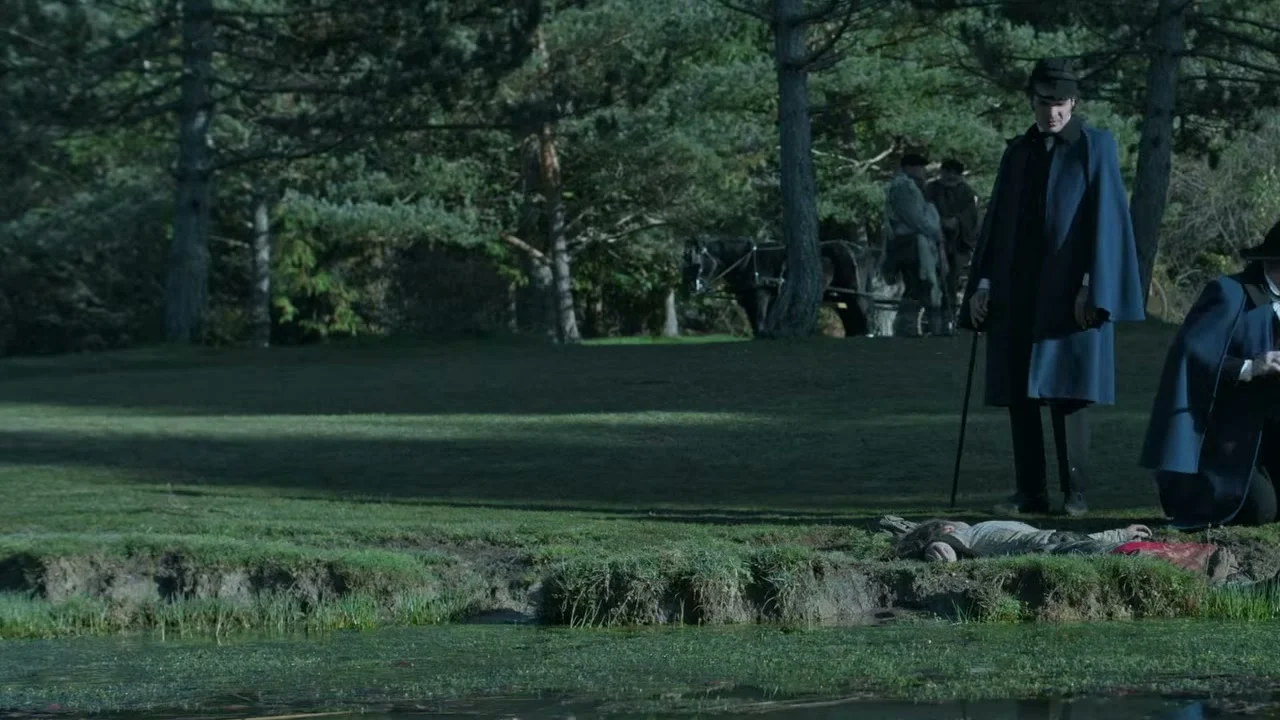Mourners walk through a cemetery in The Harvester.