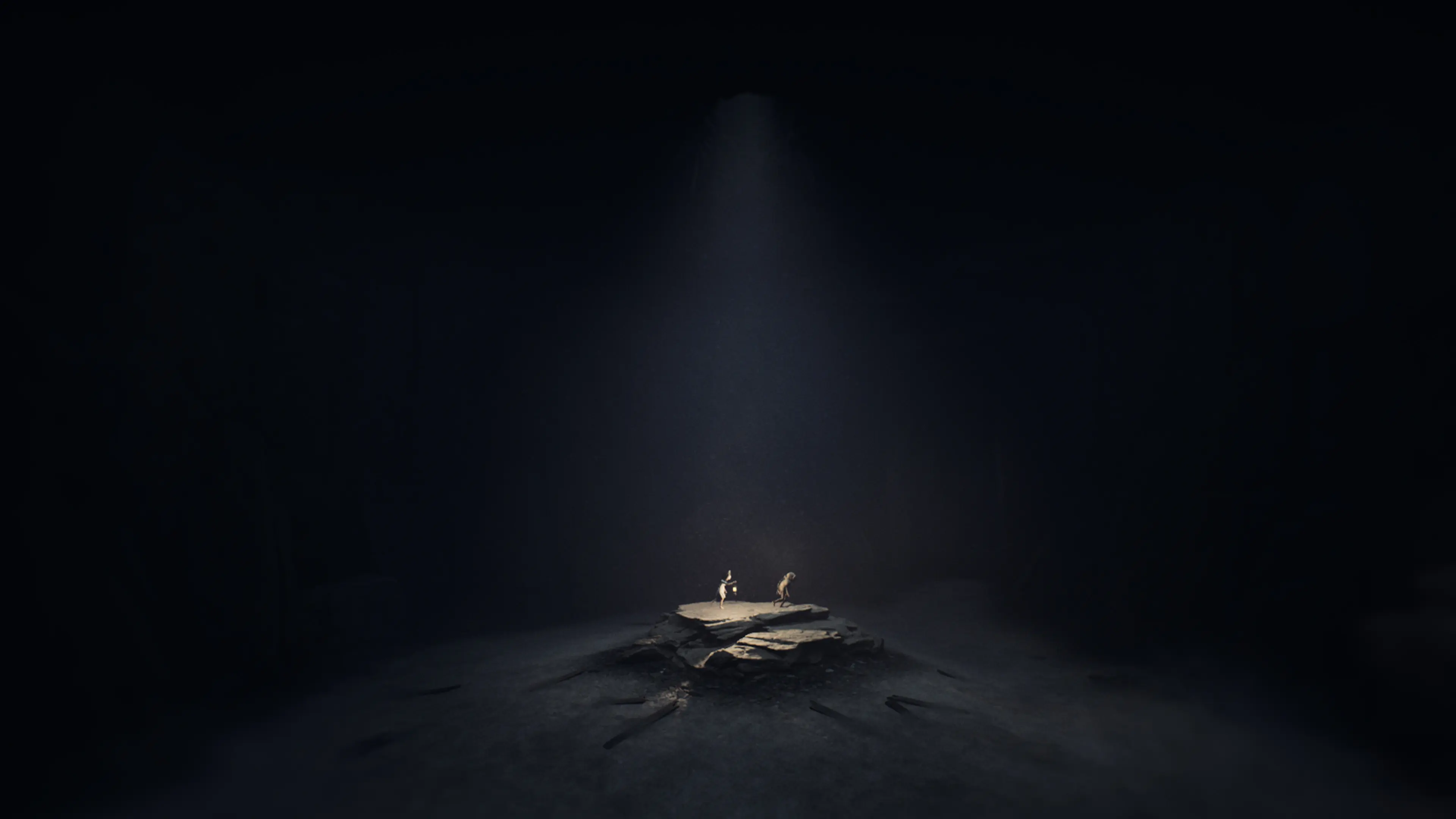 Two characters stand together under a narrow beam of light.