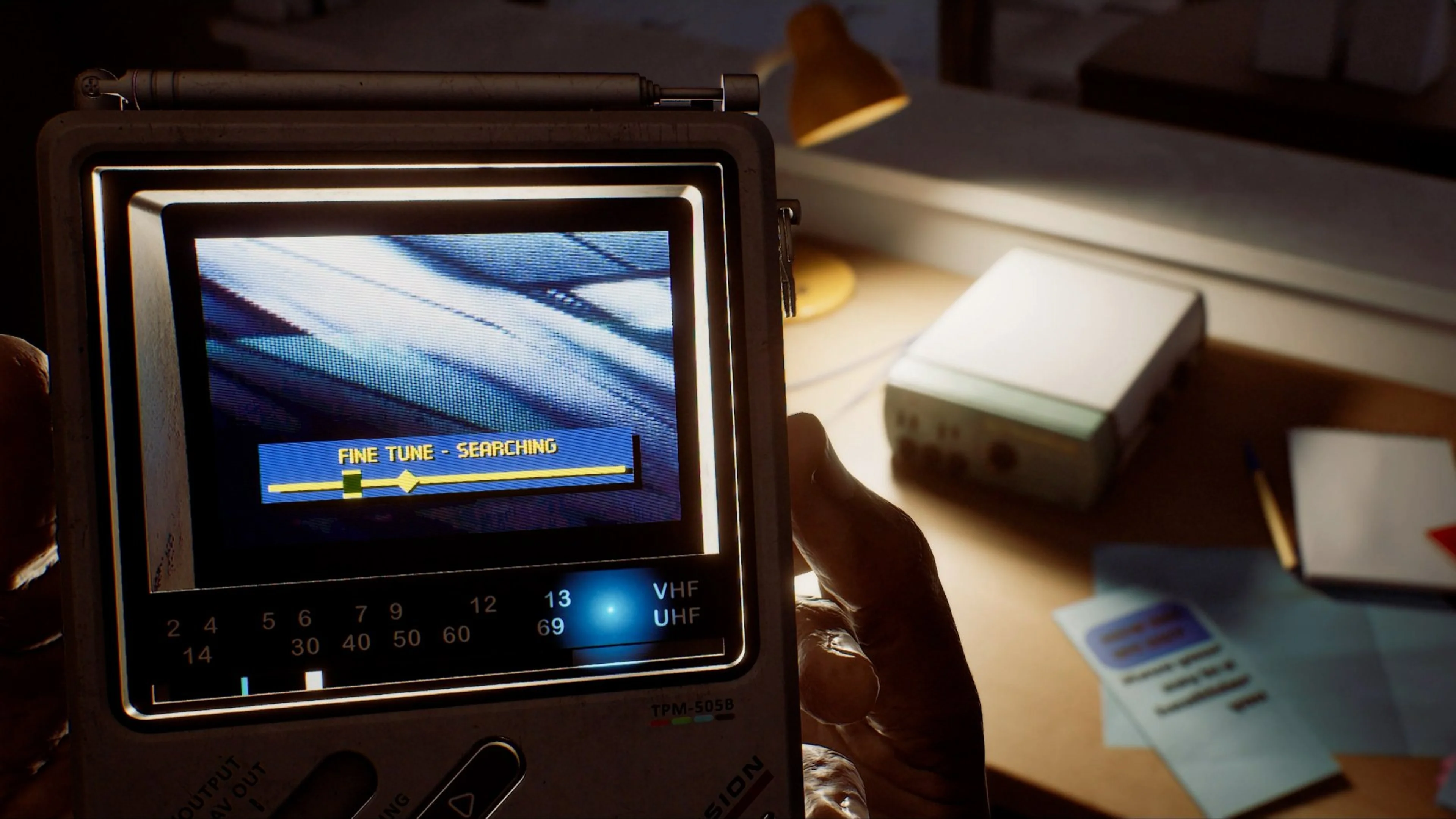 Simon holds the CRTV as it searches for an unstable signal in Silent Hill: Townfall.