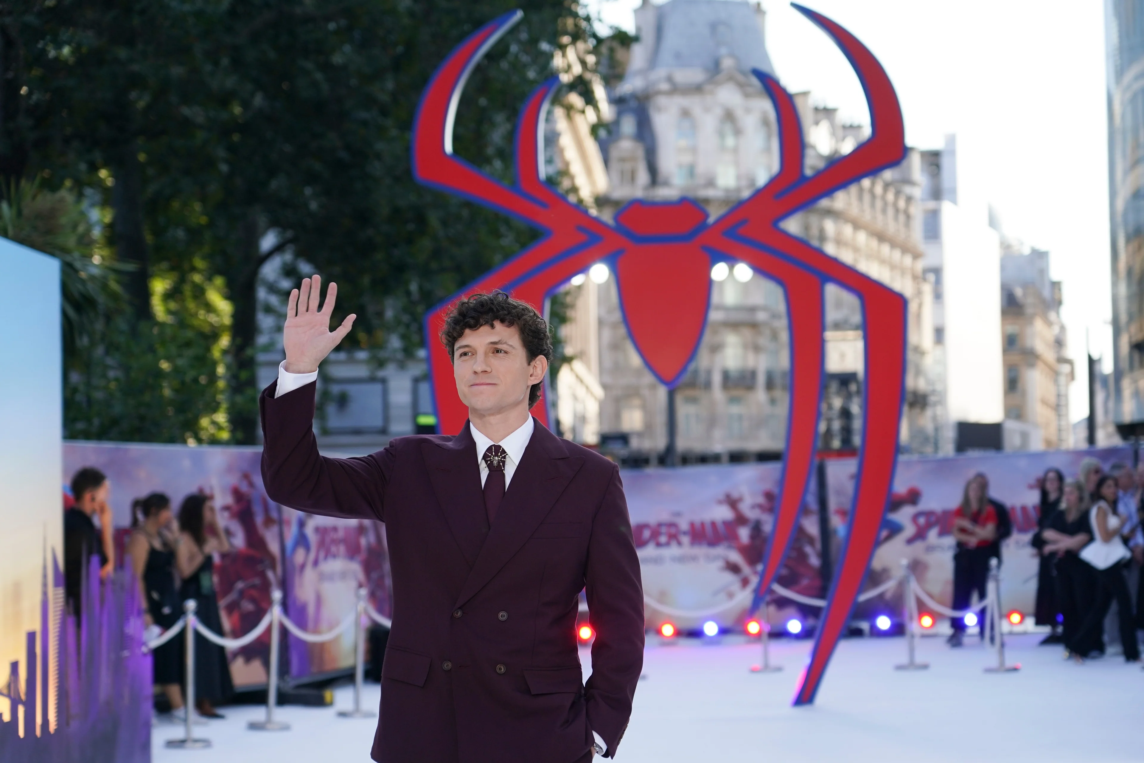 Tom Holland waves at the London premiere of Spider-Man: Brand New Day.