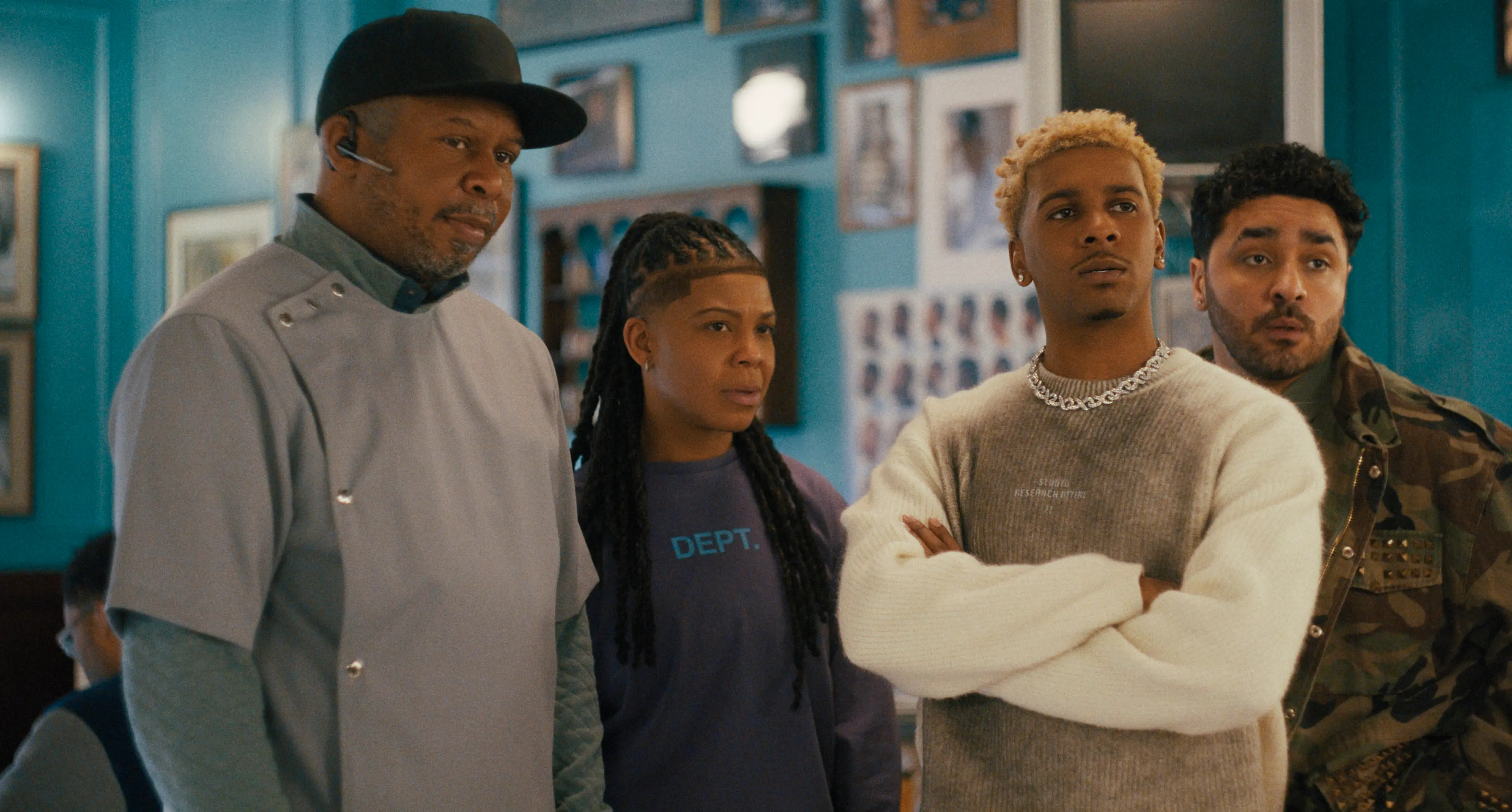 Roy Wood Jr., Punkie Johnson, Brett Gray and E.J. Bonilla stand together inside the barbershop.