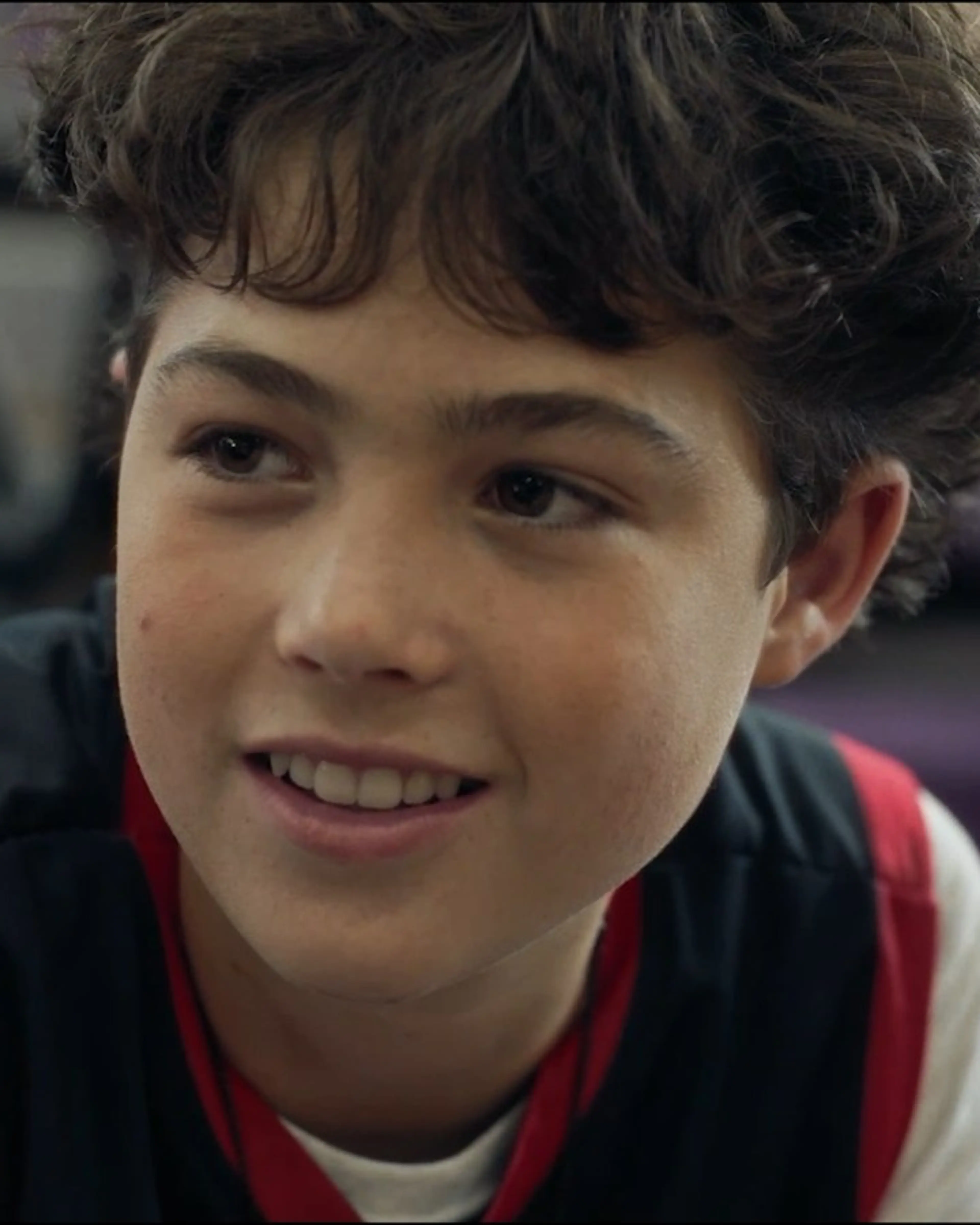 Dylan Friedman as Caden Isaacs smiles while seated in a gym in Last Shot.