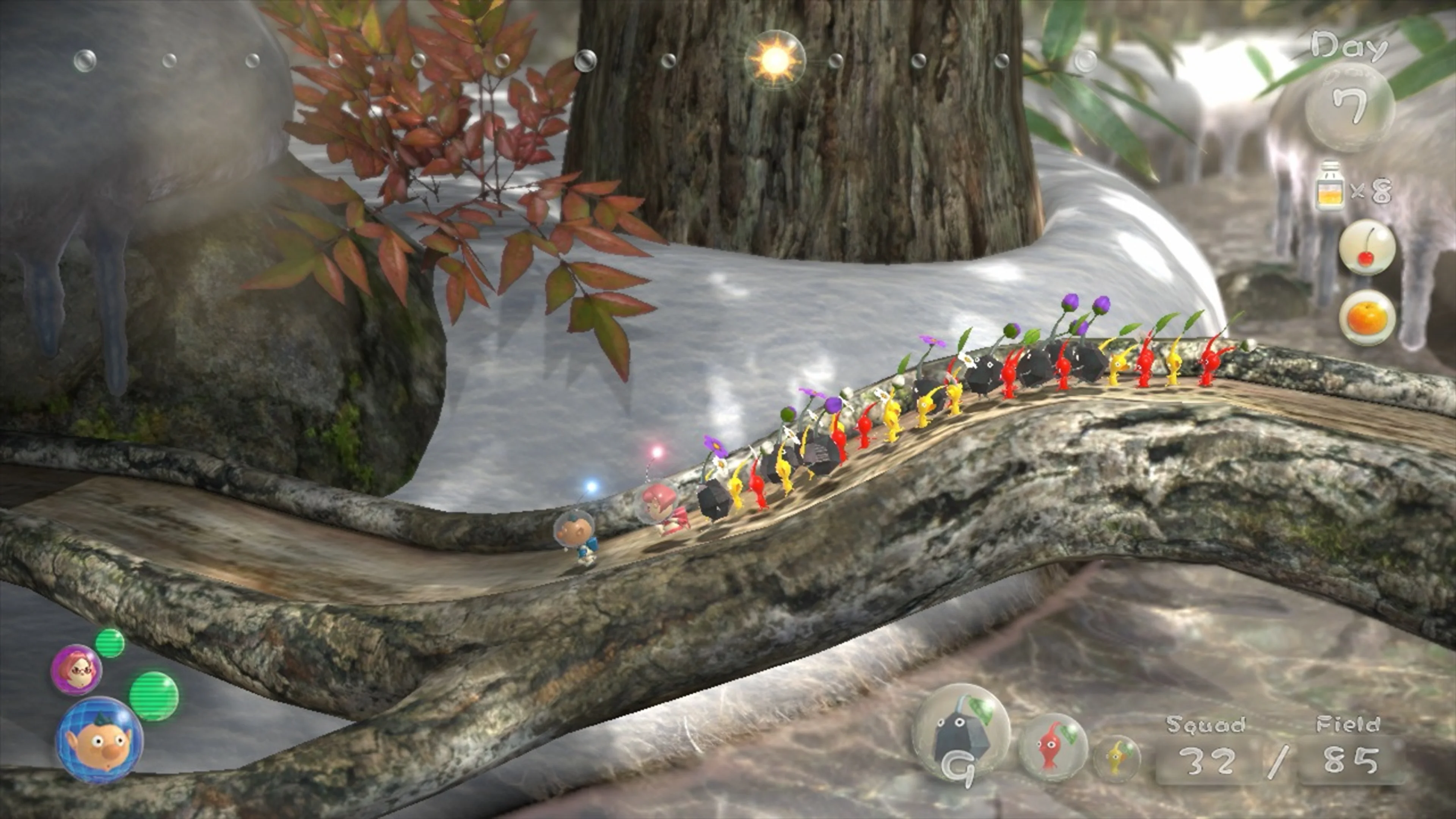 Official Pikmin 3 screenshot showing a mixed squad of Pikmin following an explorer along a garden path; type icons and the day HUD are visible.