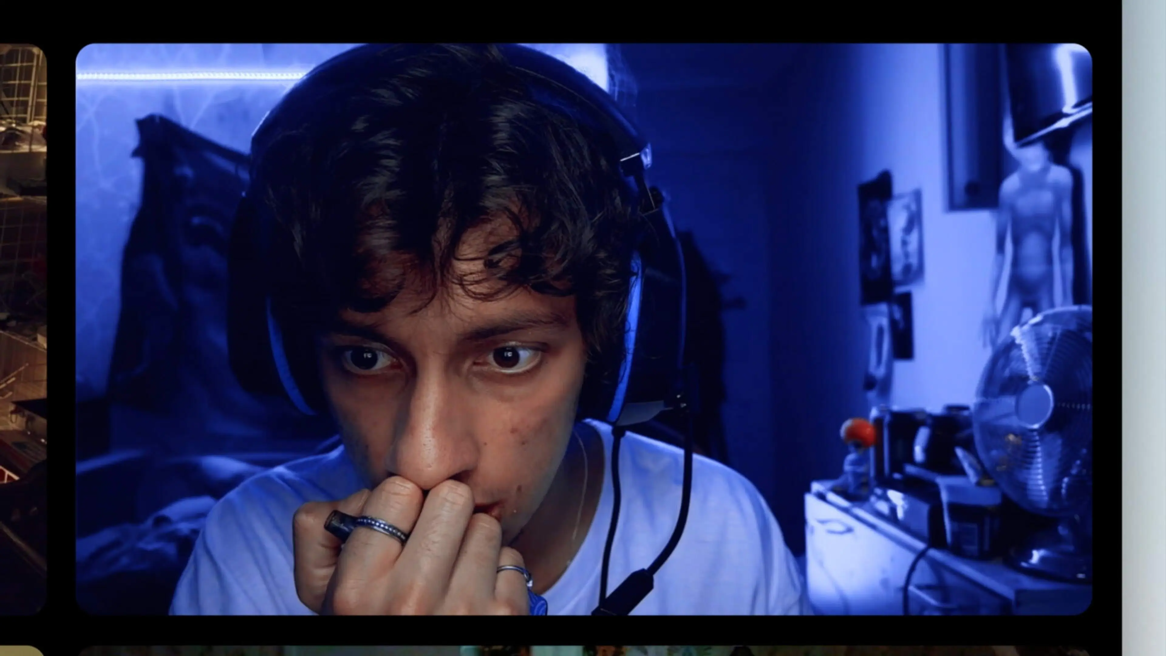Sid wears a white hoodie and headphones in a blue-lit bedroom.