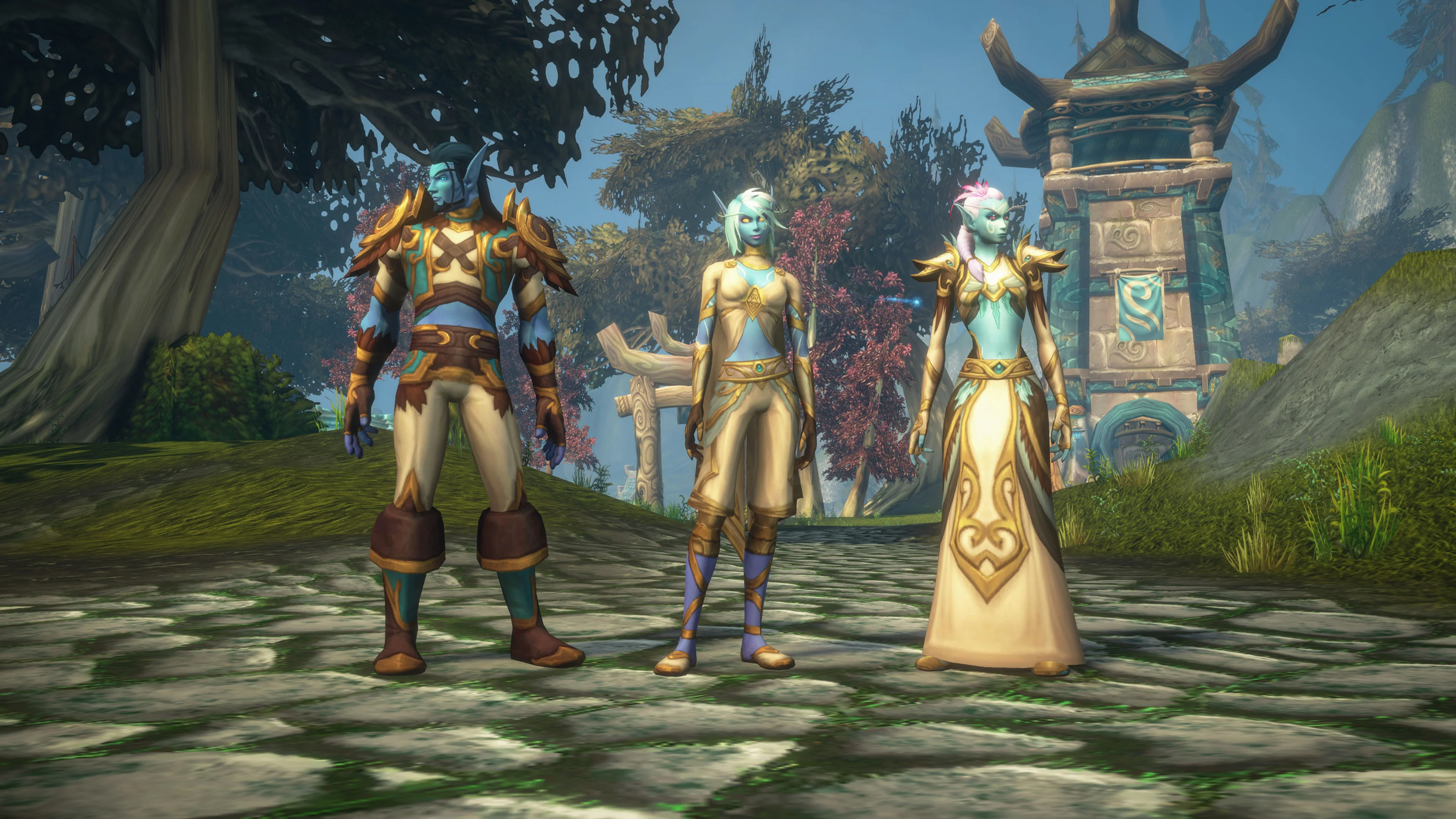 Three Skyborne Elf character models stand beside a carved stone monument in World of Warcraft: Forever.