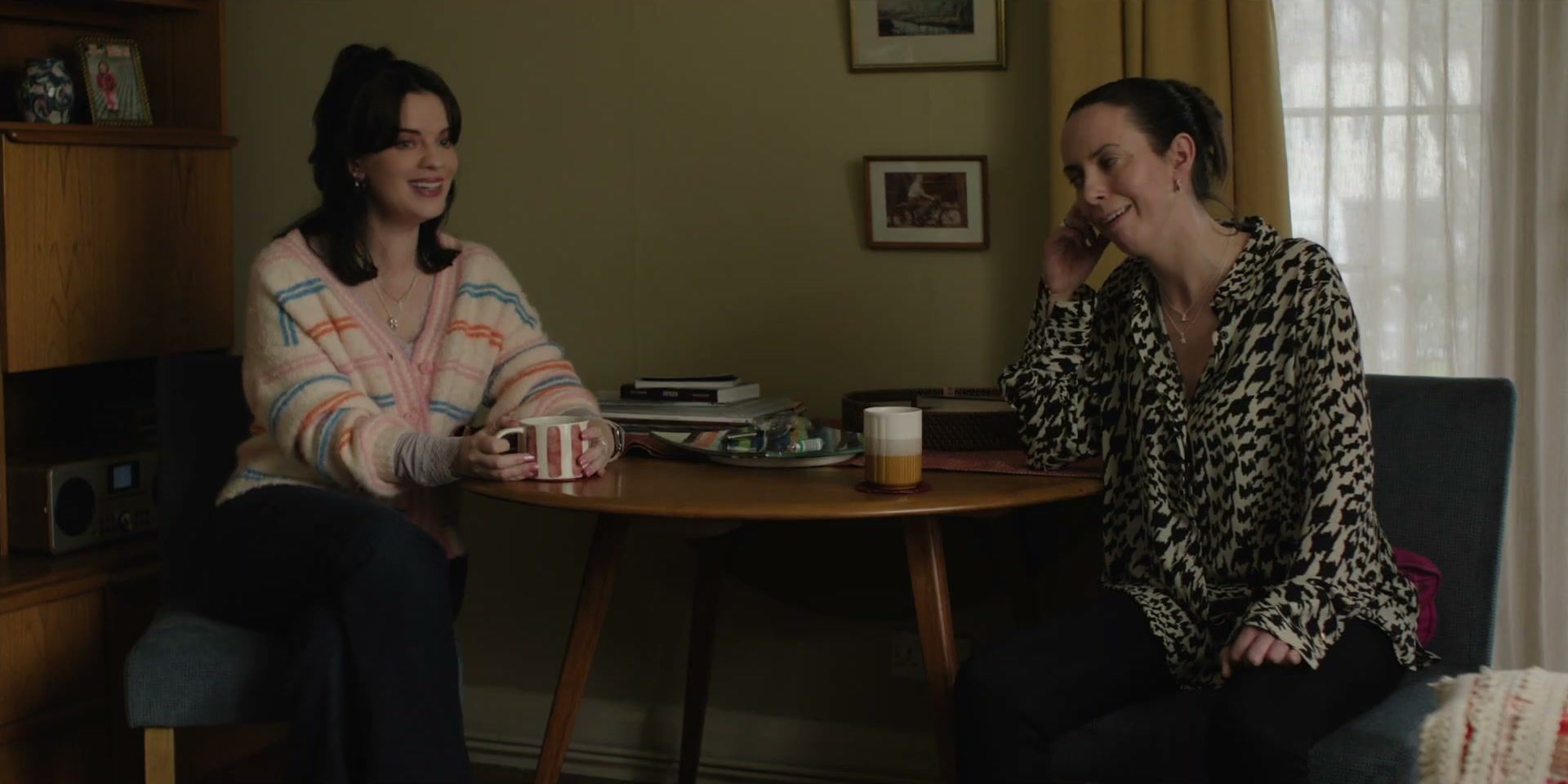 Amy and Rosie talk at a kitchen table in Tender Loving Care.