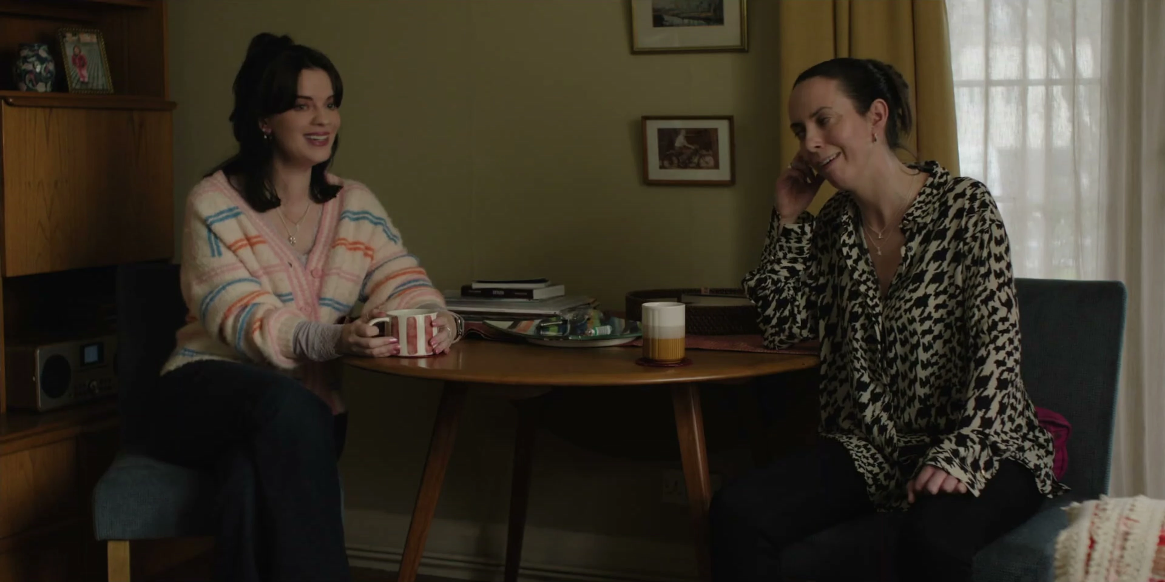 Amy and Rosie talk at a kitchen table in Tender Loving Care.