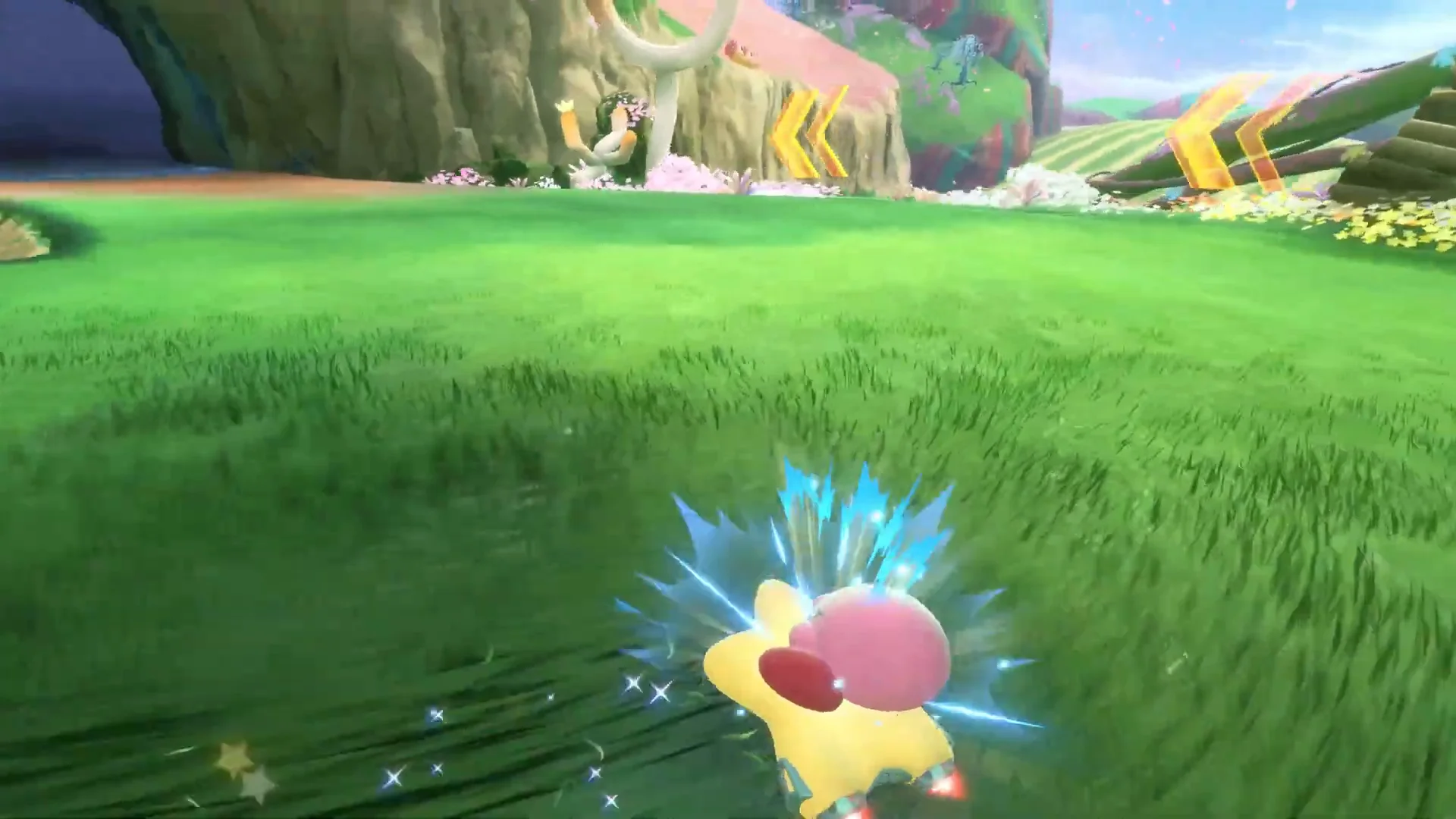 Official Nintendo UK Kirby Air Riders gameplay frame showing blue sparks around Kirby’s Warp Star during a left-hand drift.