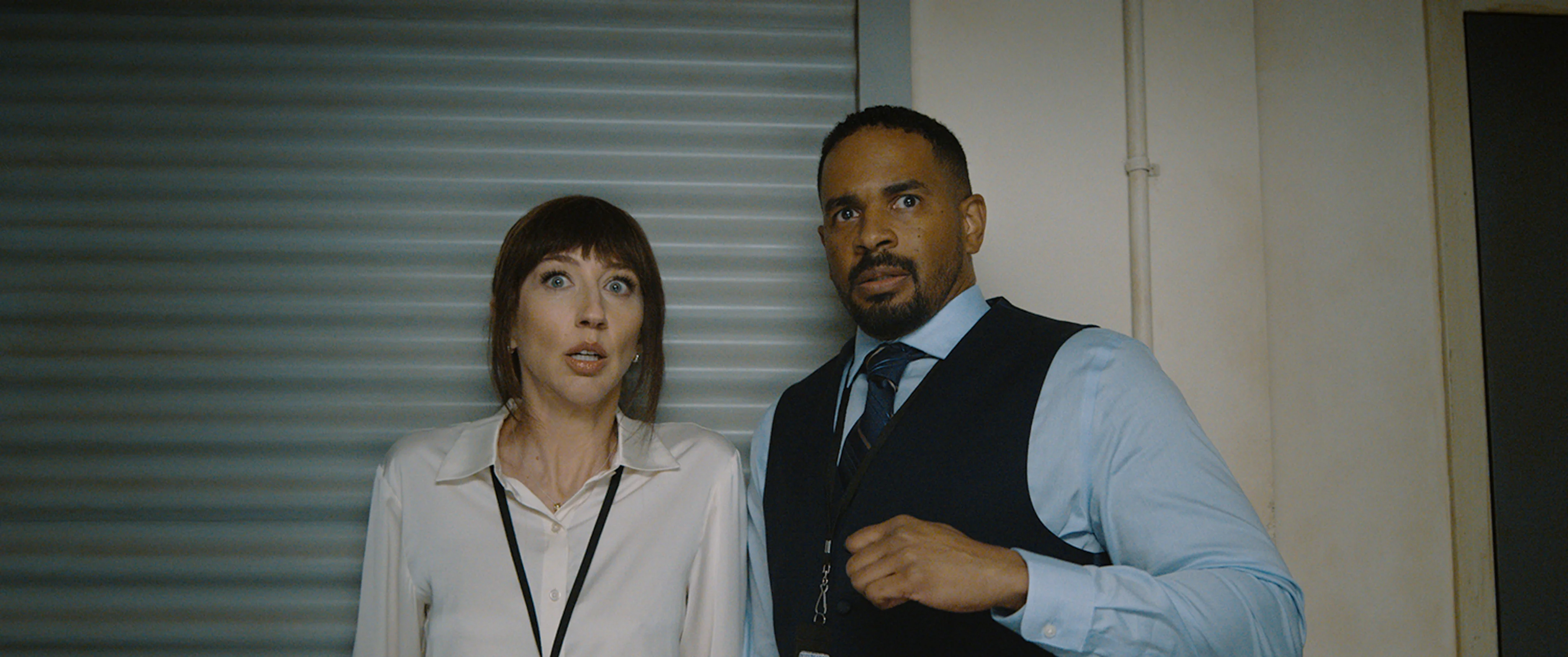 Two characters react to danger in a still from Scary Movie (2026).