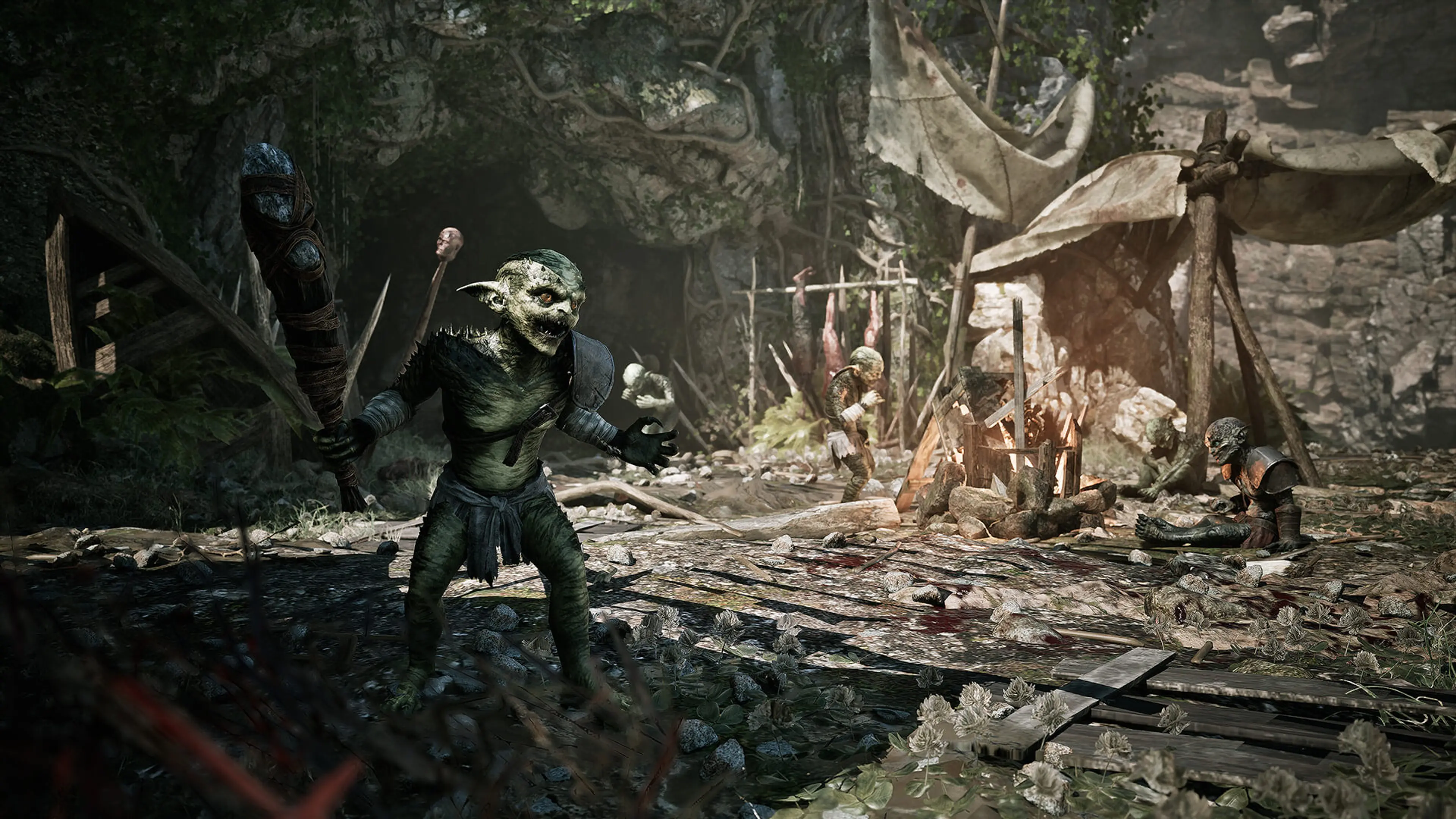 A goblin-like creature holds a club inside a camp.