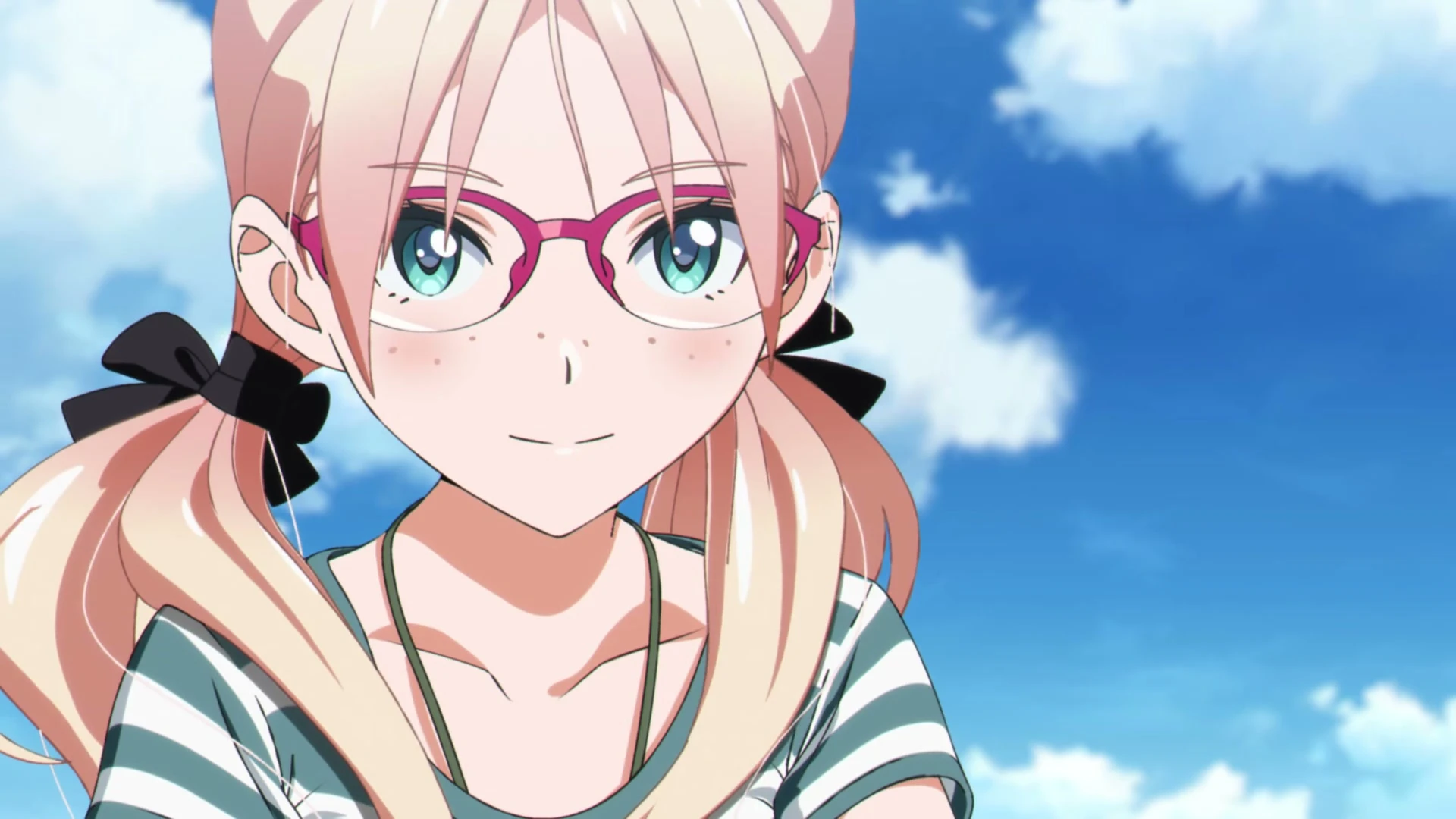 A young woman with pink hair and glasses smiles beneath a clear blue sky.