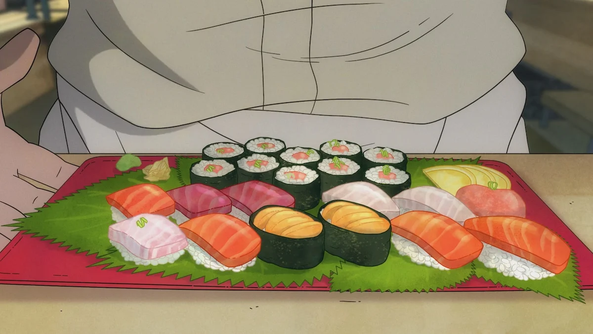 A tray holds neatly arranged sushi in front of a person wearing a white outfit.