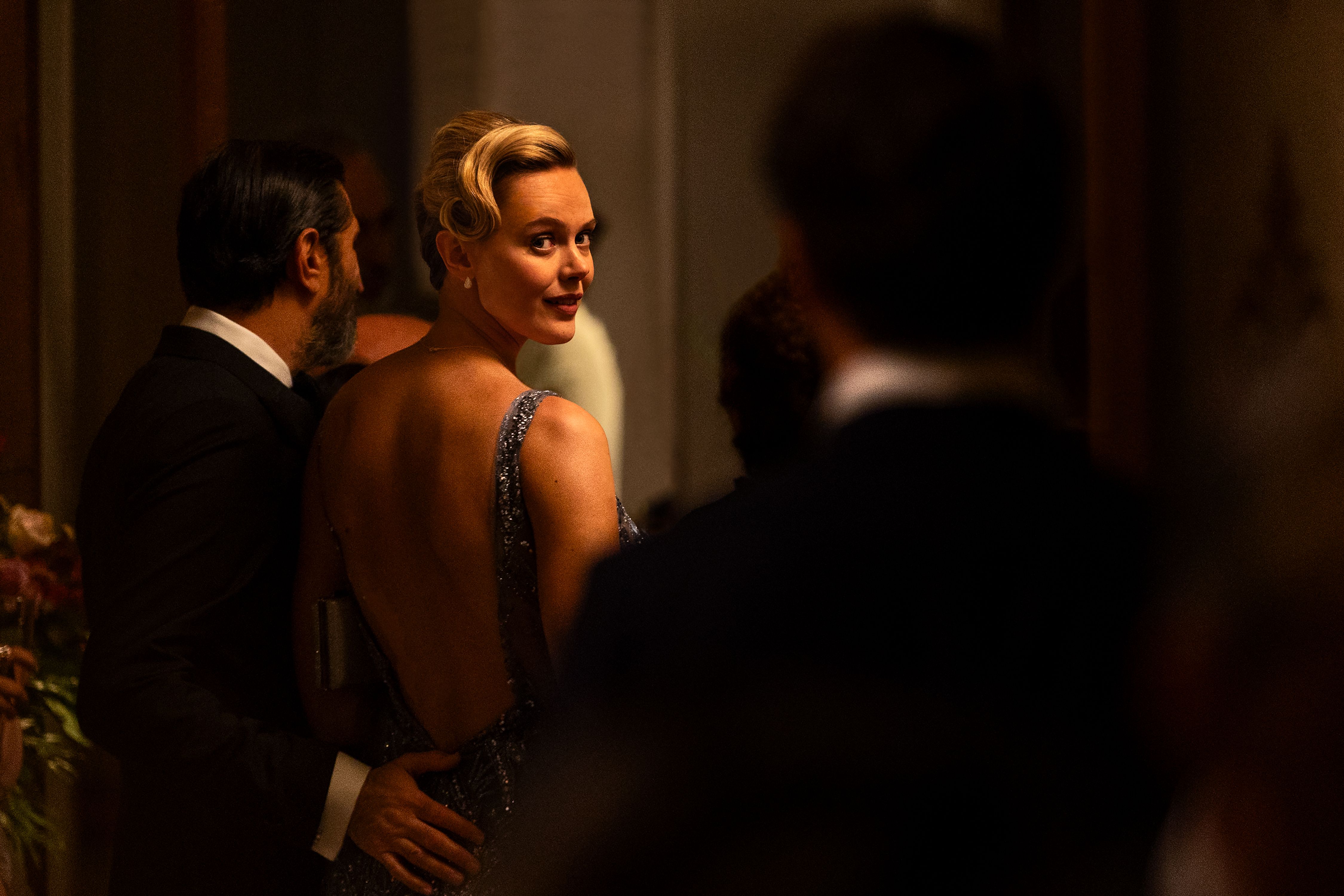 Frida Gustavsson as Helene looks back across a formal reception in A Couple of Lies.