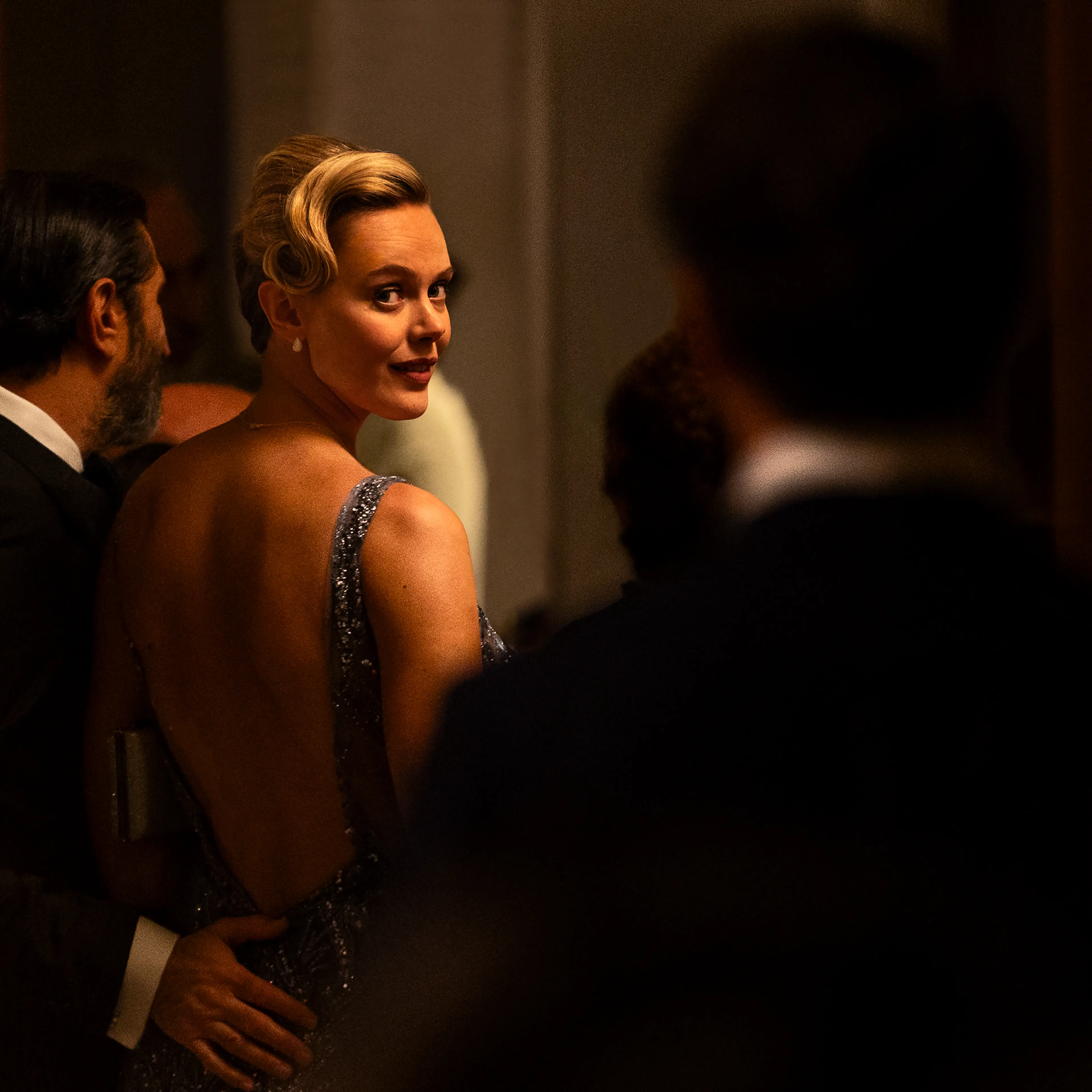 Frida Gustavsson as Helene looks back across a formal reception in A Couple of Lies.