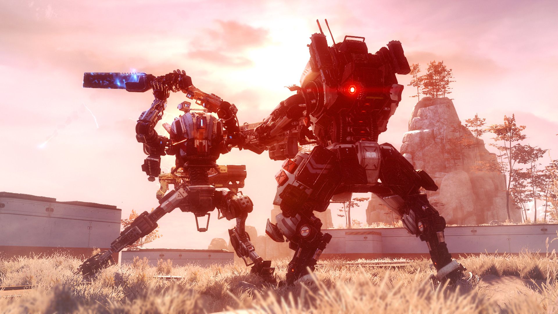 Two large Titans fight amid explosions in a rocky field.