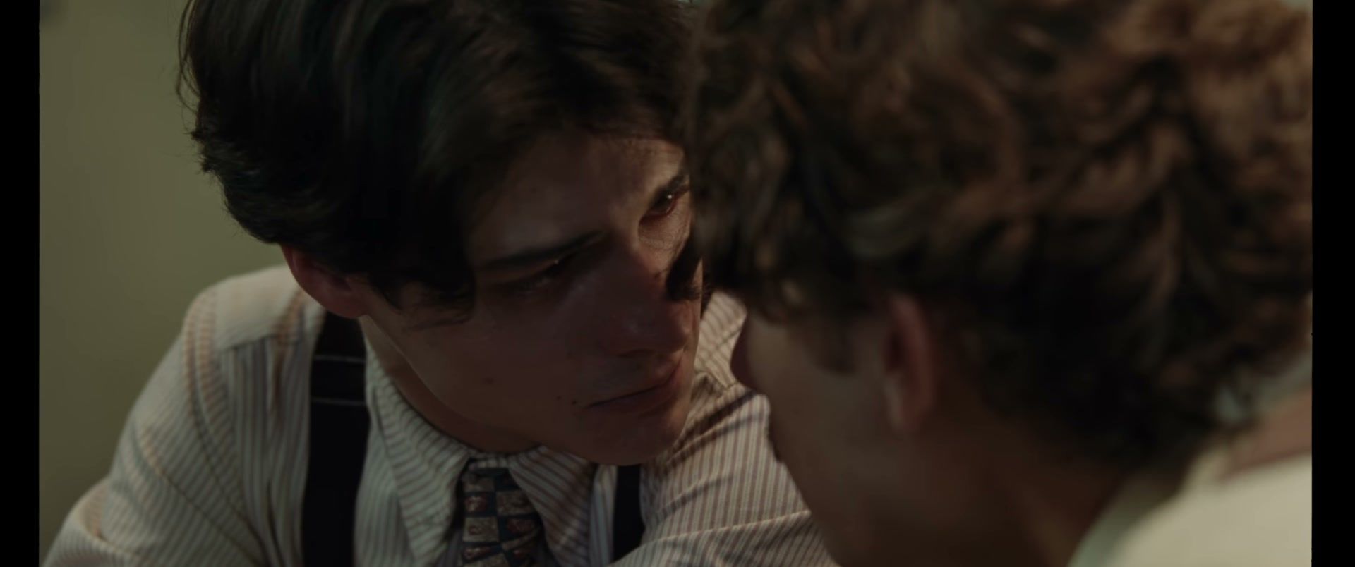 Two young men face each other closely in La Bola Negra.