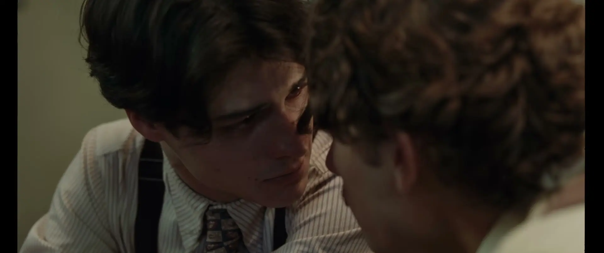 Two young men face each other closely in La Bola Negra.