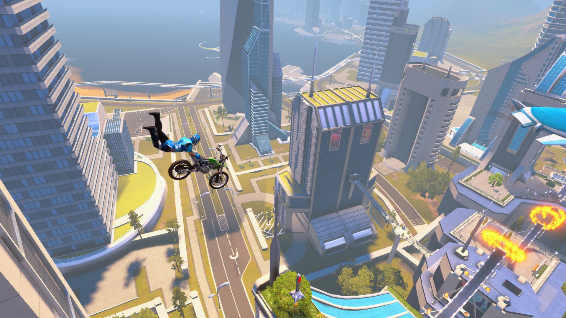 A rider and bike jump above a futuristic city track.