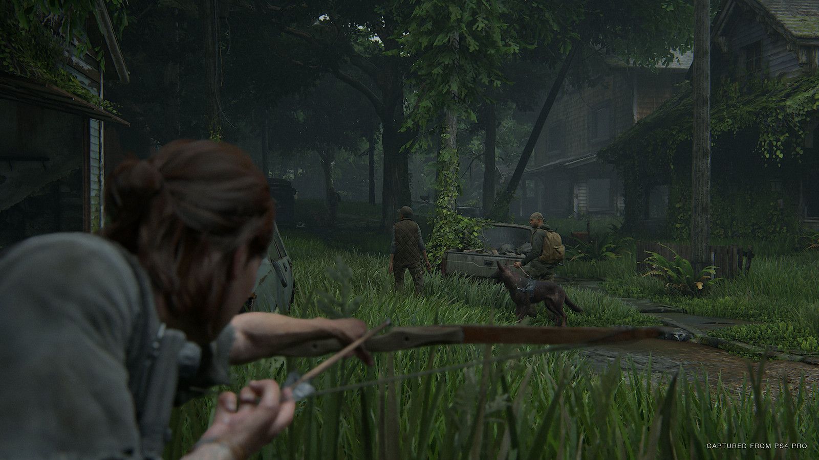 Ellie aims a bow from tall grass at an enemy ahead.