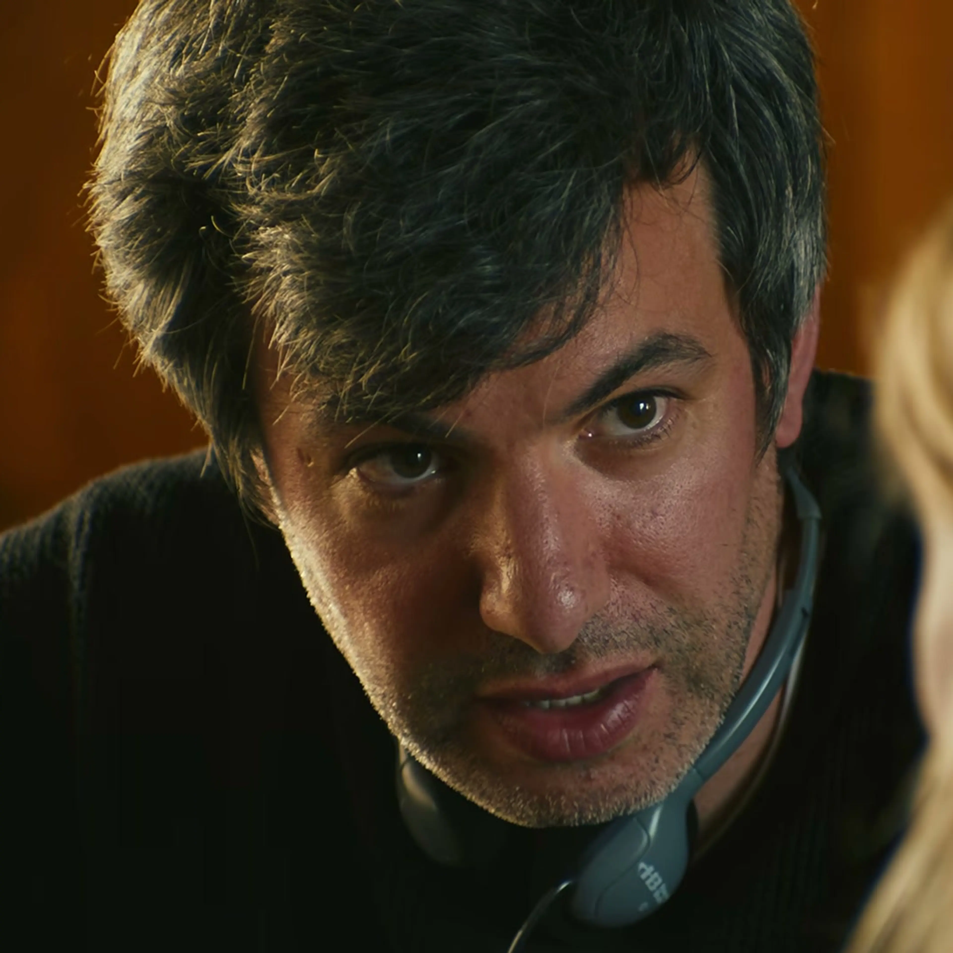 Nathan Fielder leans across a table in You Can See Everything.