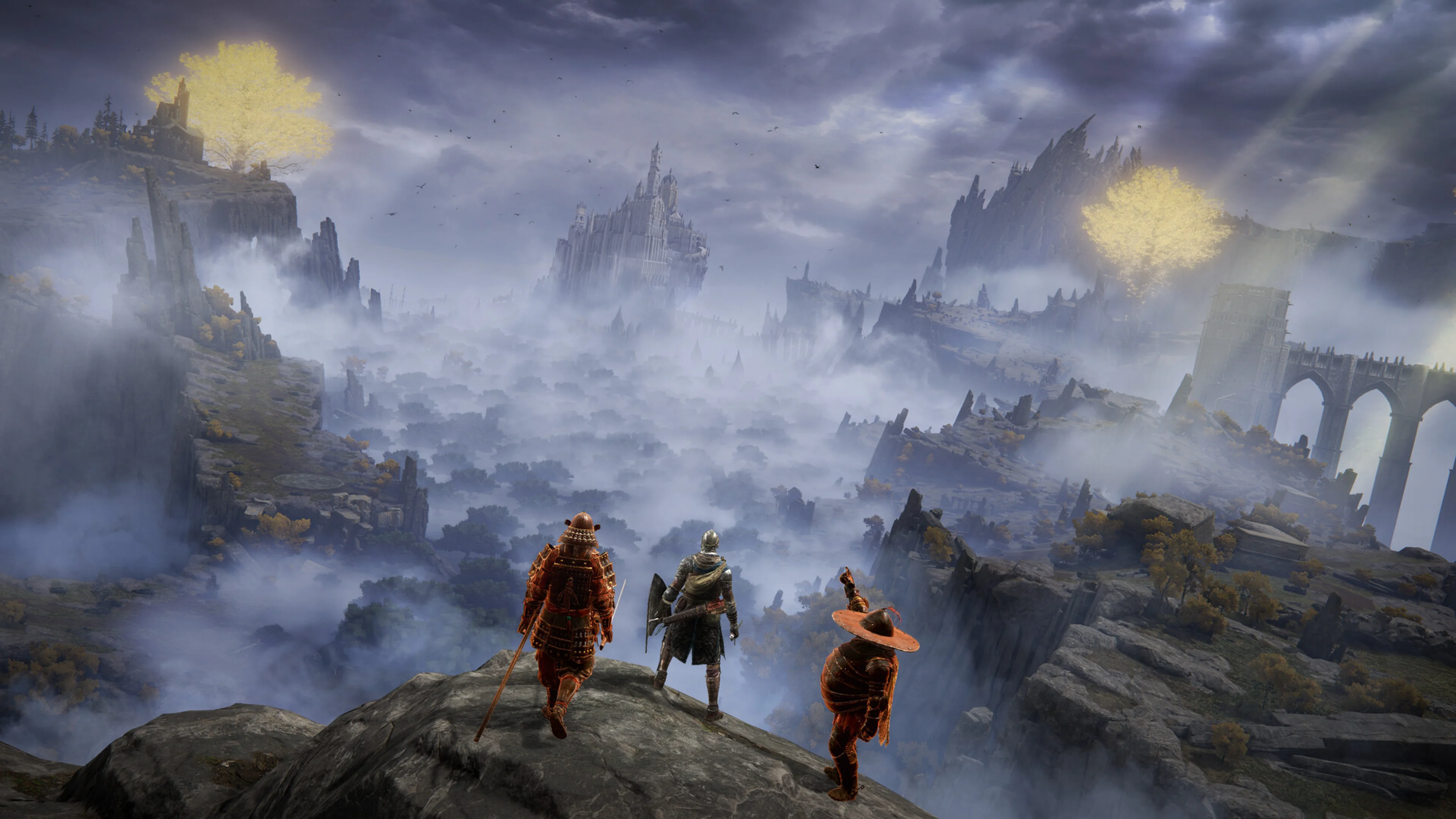 Three Tarnished look across the Lands Between toward distant castles and glowing Erdtree branches.