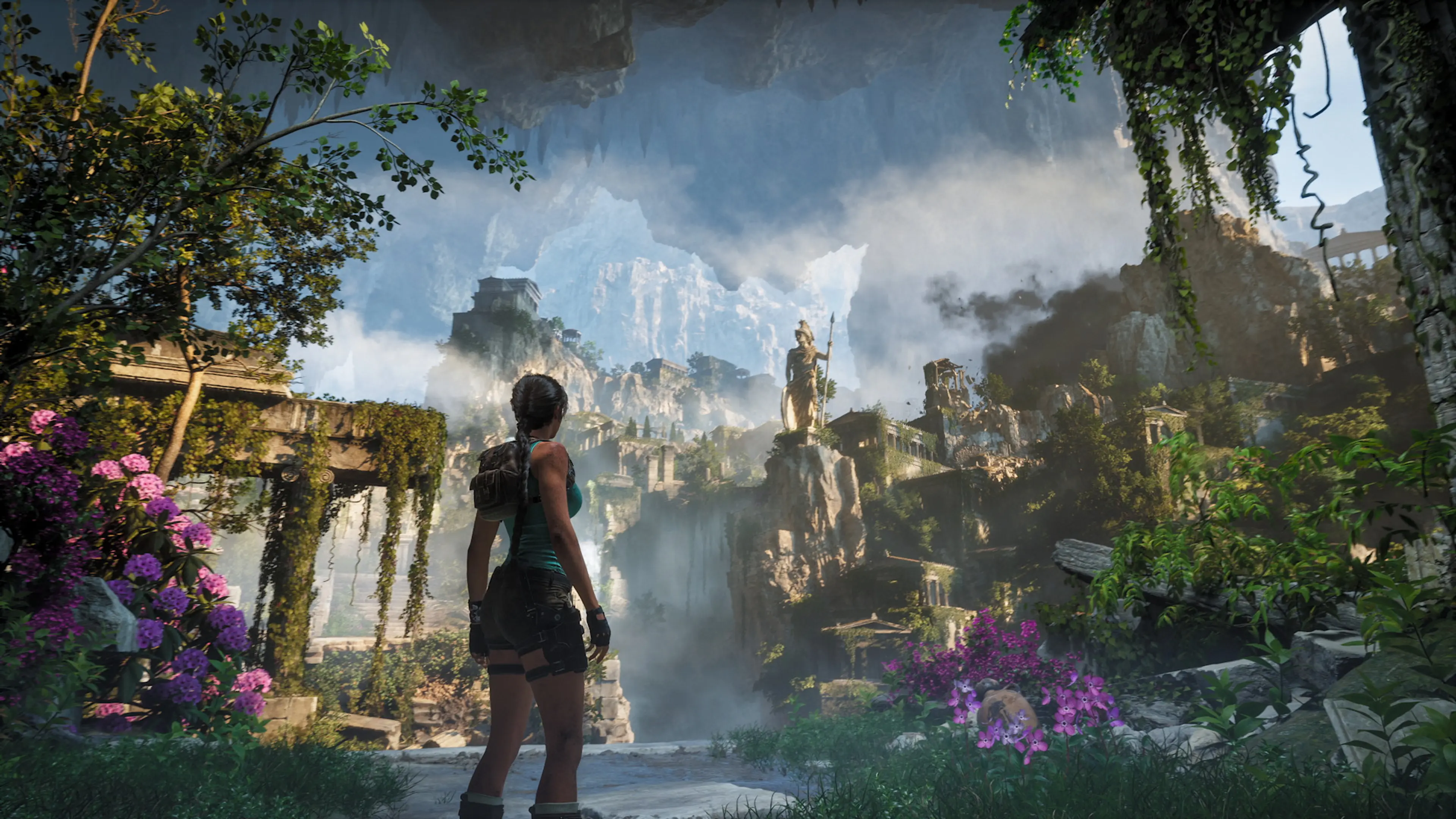 Lara Croft overlooks Greek ruins, waterfalls, statues, and mountain cliffs in Tomb Raider: Legacy of Atlantis.