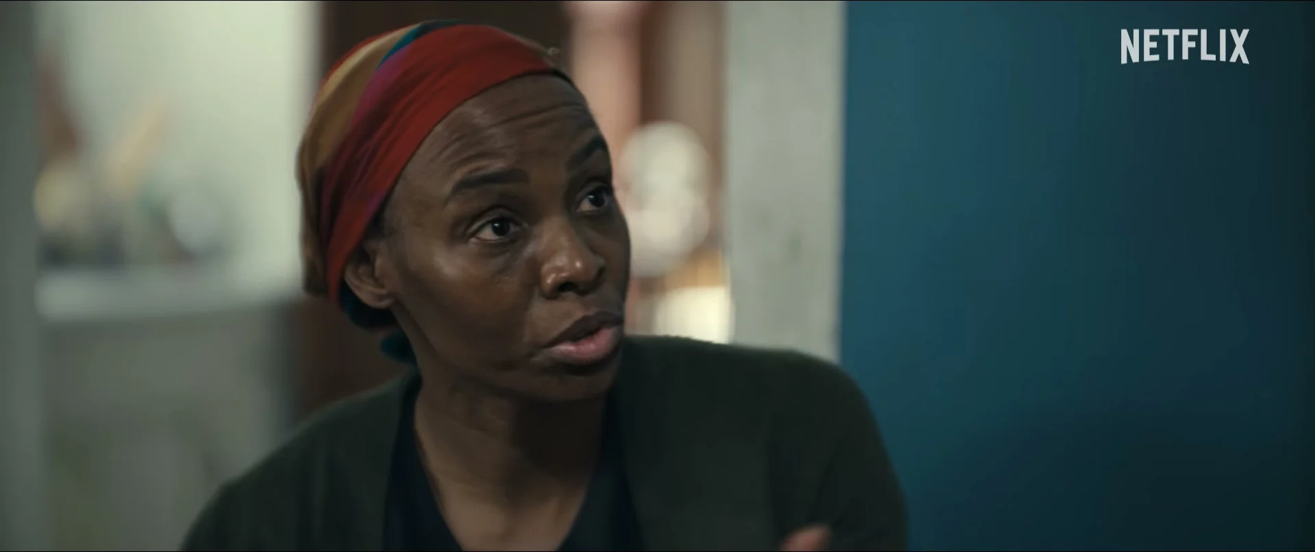 A woman wearing a red headwrap appears in Doing Life.