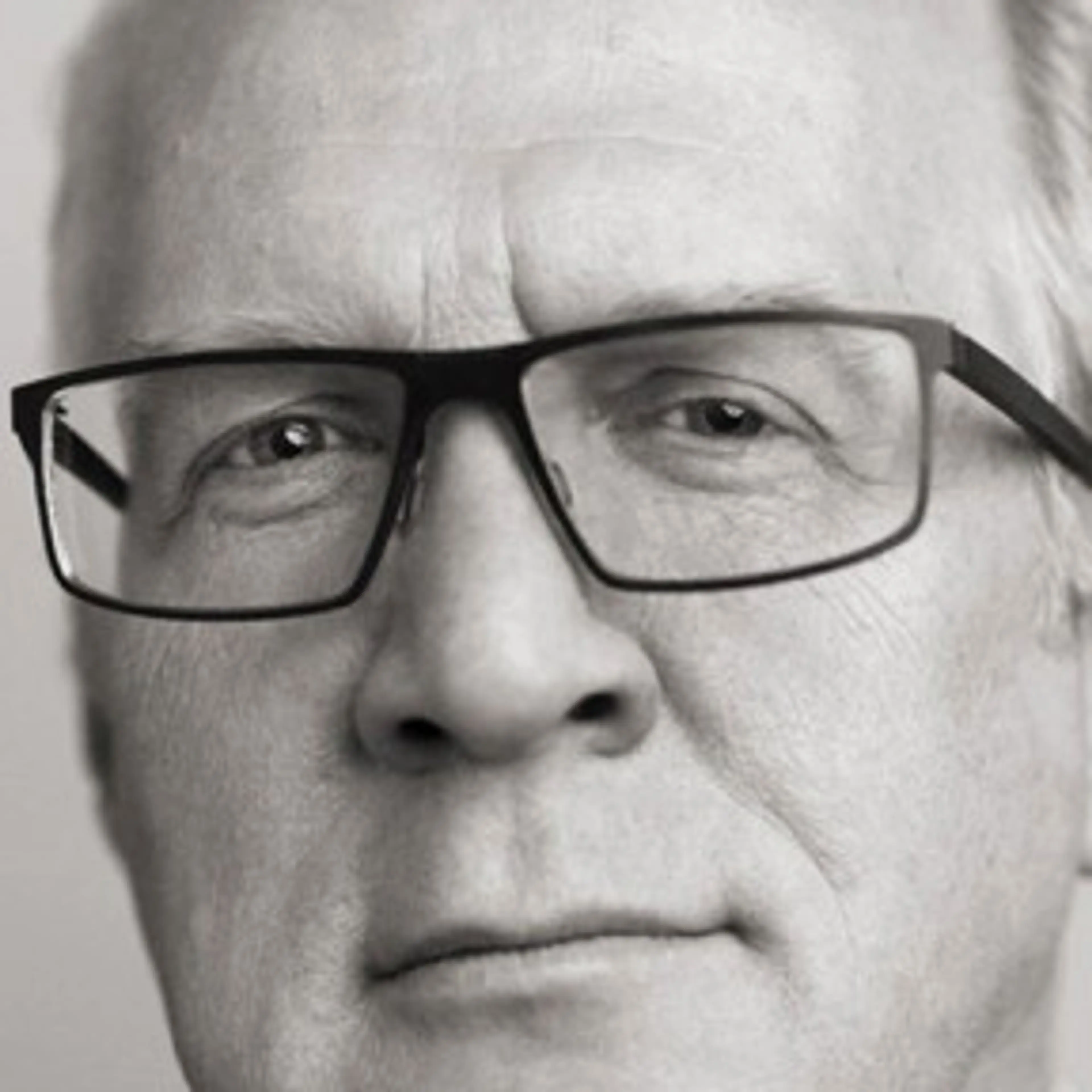 Black-and-white portrait of Tracy Letts wearing glasses.