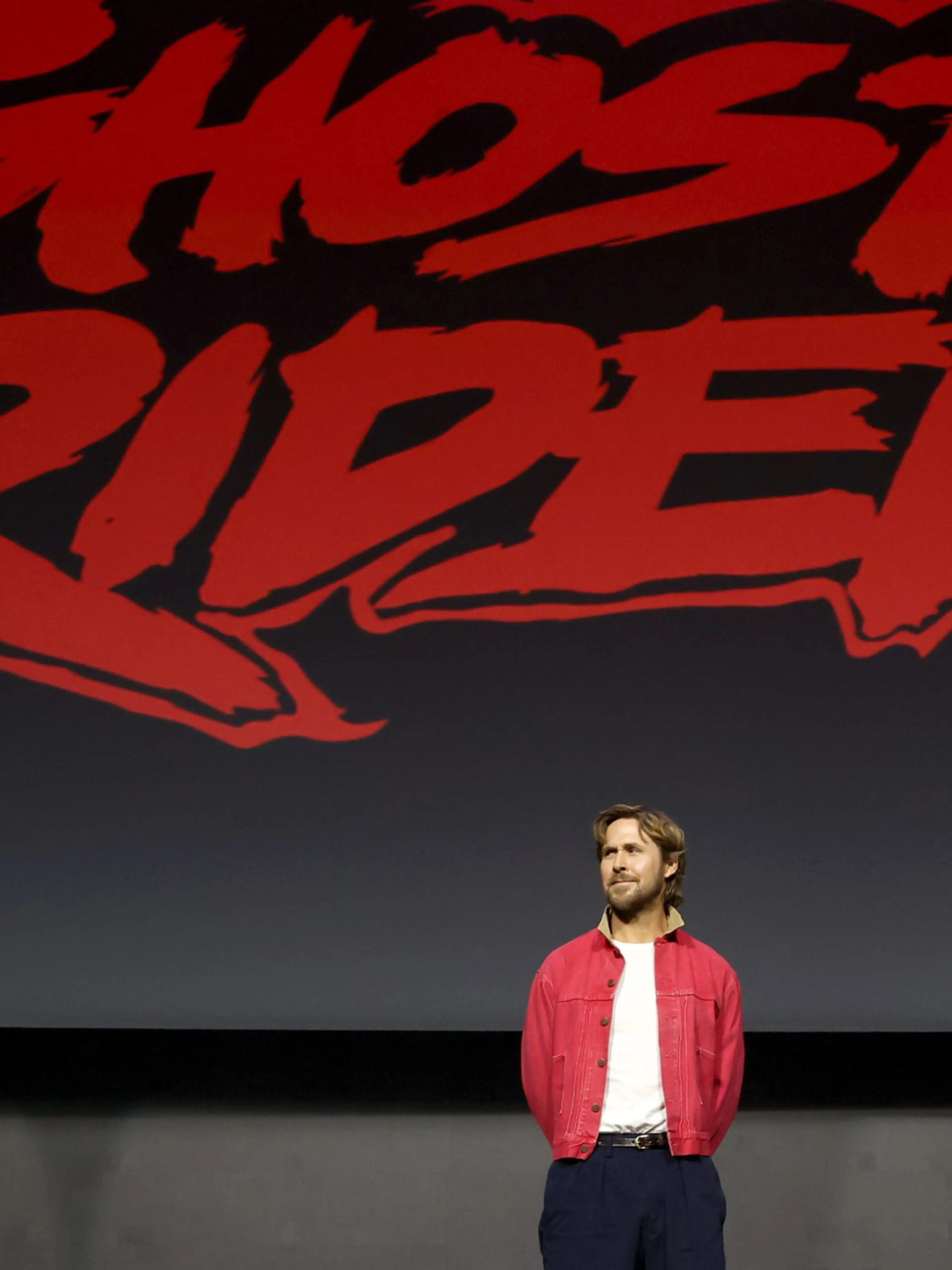 Ryan Gosling stands beneath the Ghost Rider title during Marvel Studios' 2026 San Diego Comic-Con panel.