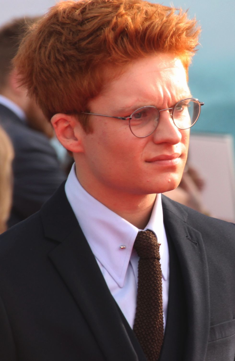 Tom Glynn-Carney wearing glasses and a suit at the French Dunkirk premiere in July 2017.
