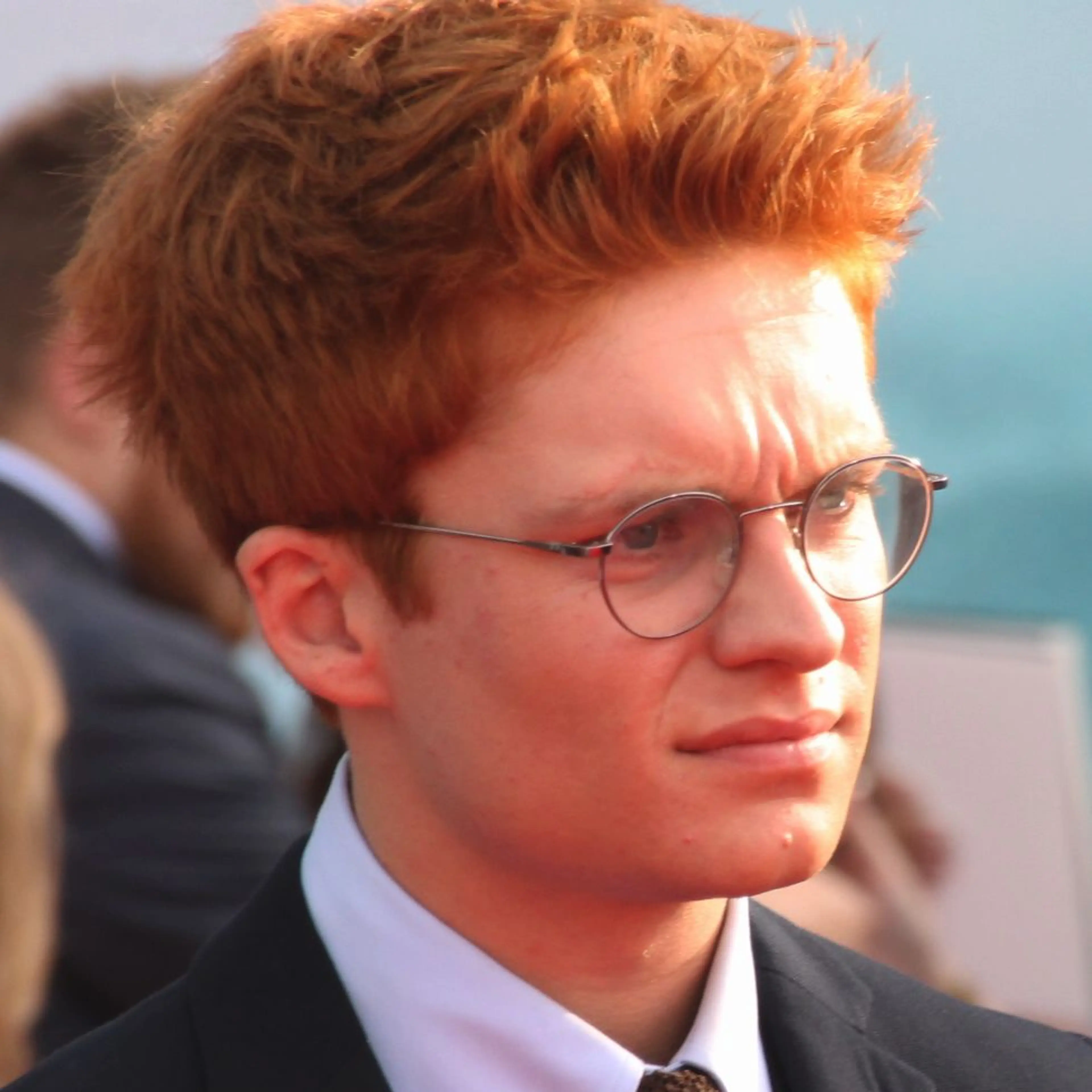 Tom Glynn-Carney wearing glasses and a suit at the French Dunkirk premiere in July 2017.