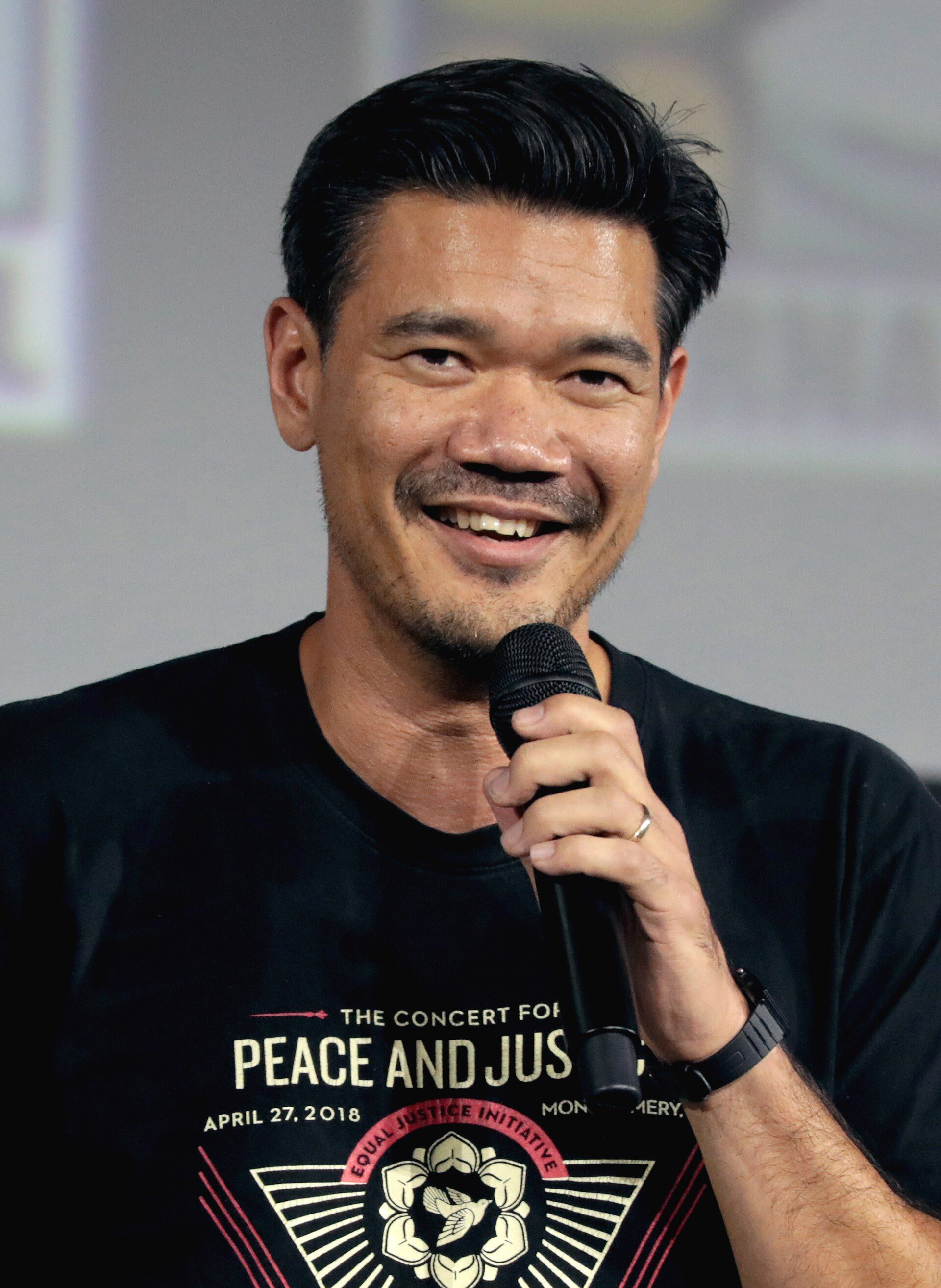 Director Destin Daniel Cretton speaks into a microphone at San Diego Comic-Con.