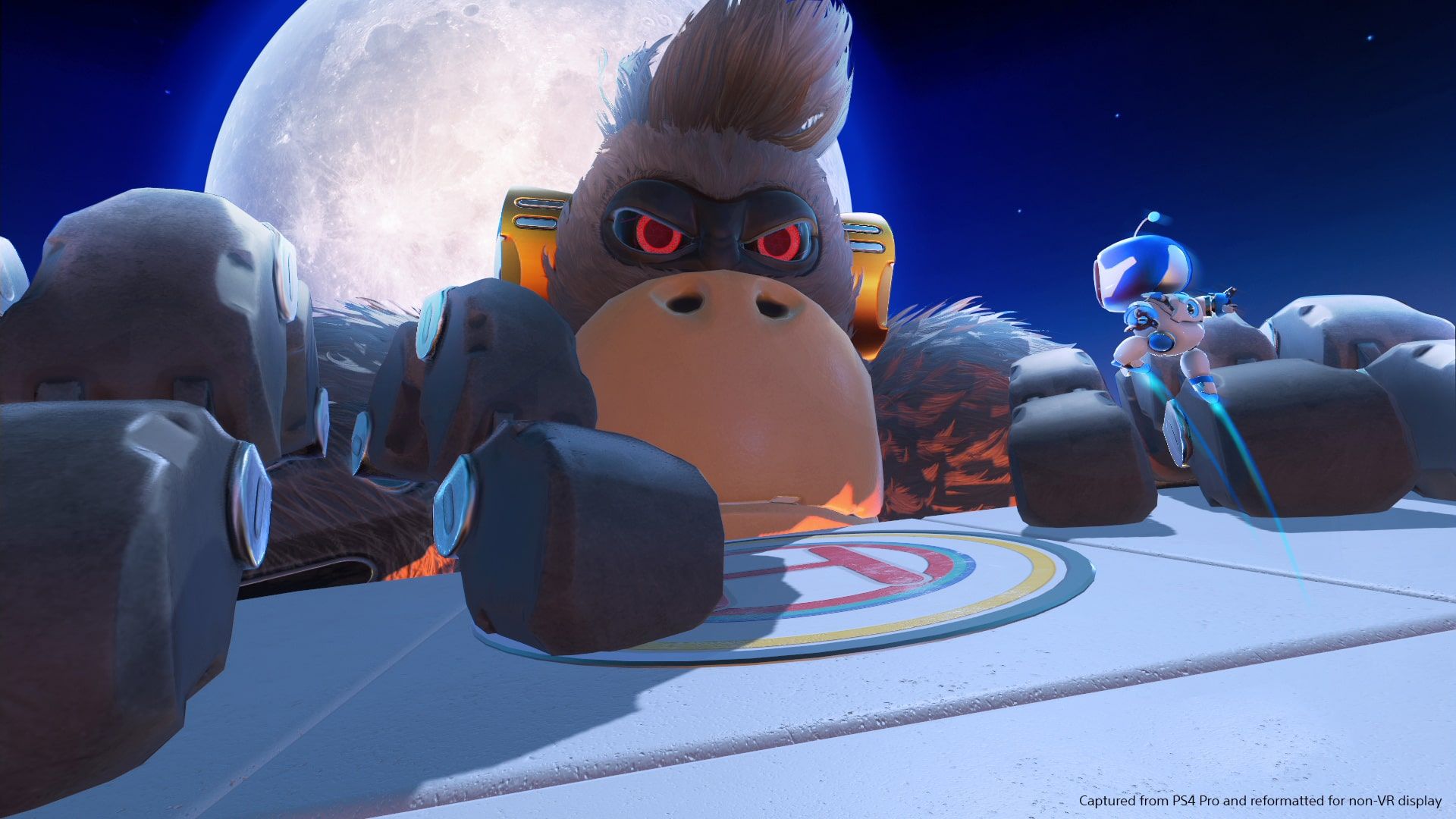 Astro faces a huge gorilla-like robot boss in a colourful arena.