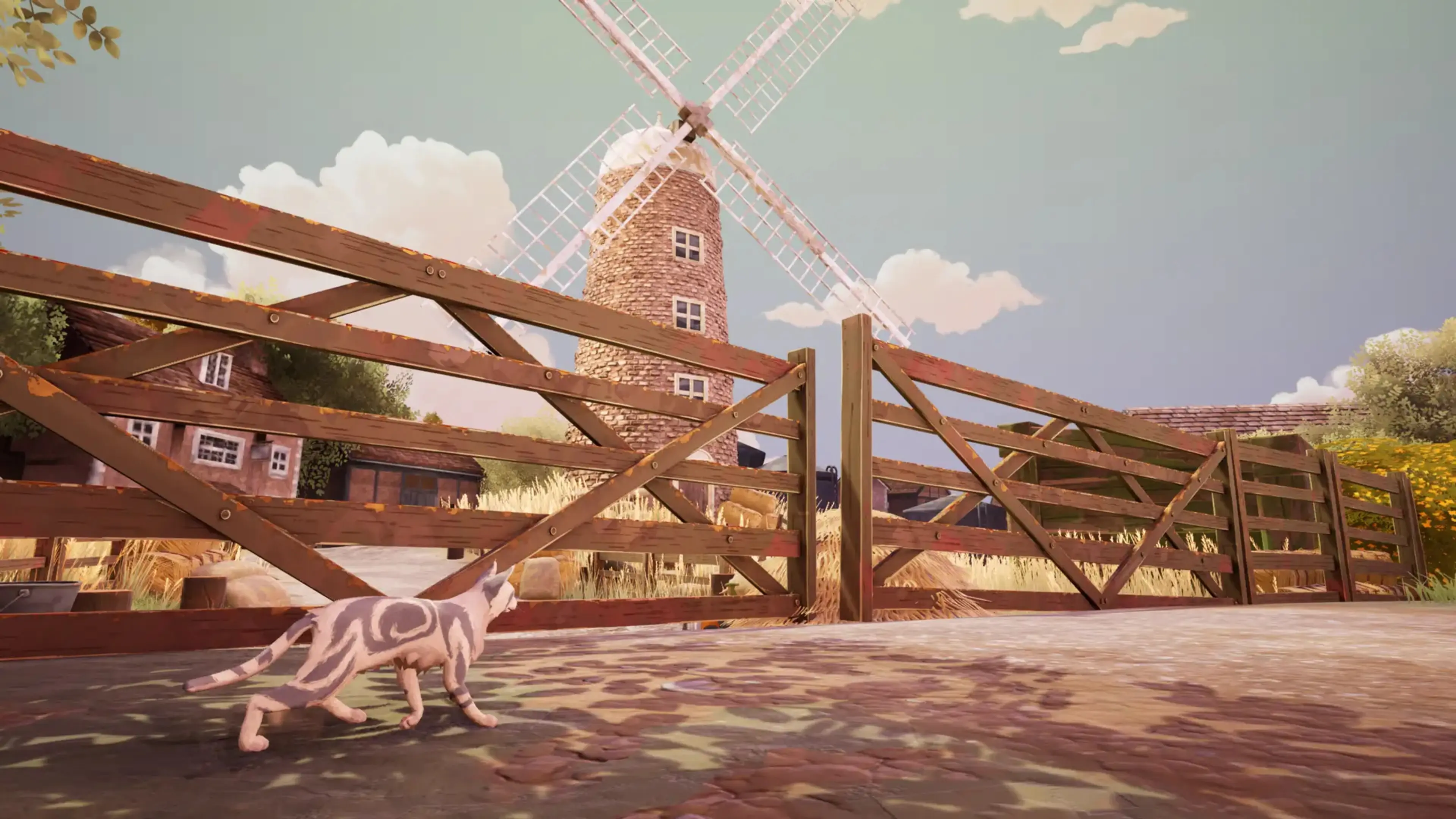 A warrior cat walks beside a wooden gate as a windmill turns in the distance.