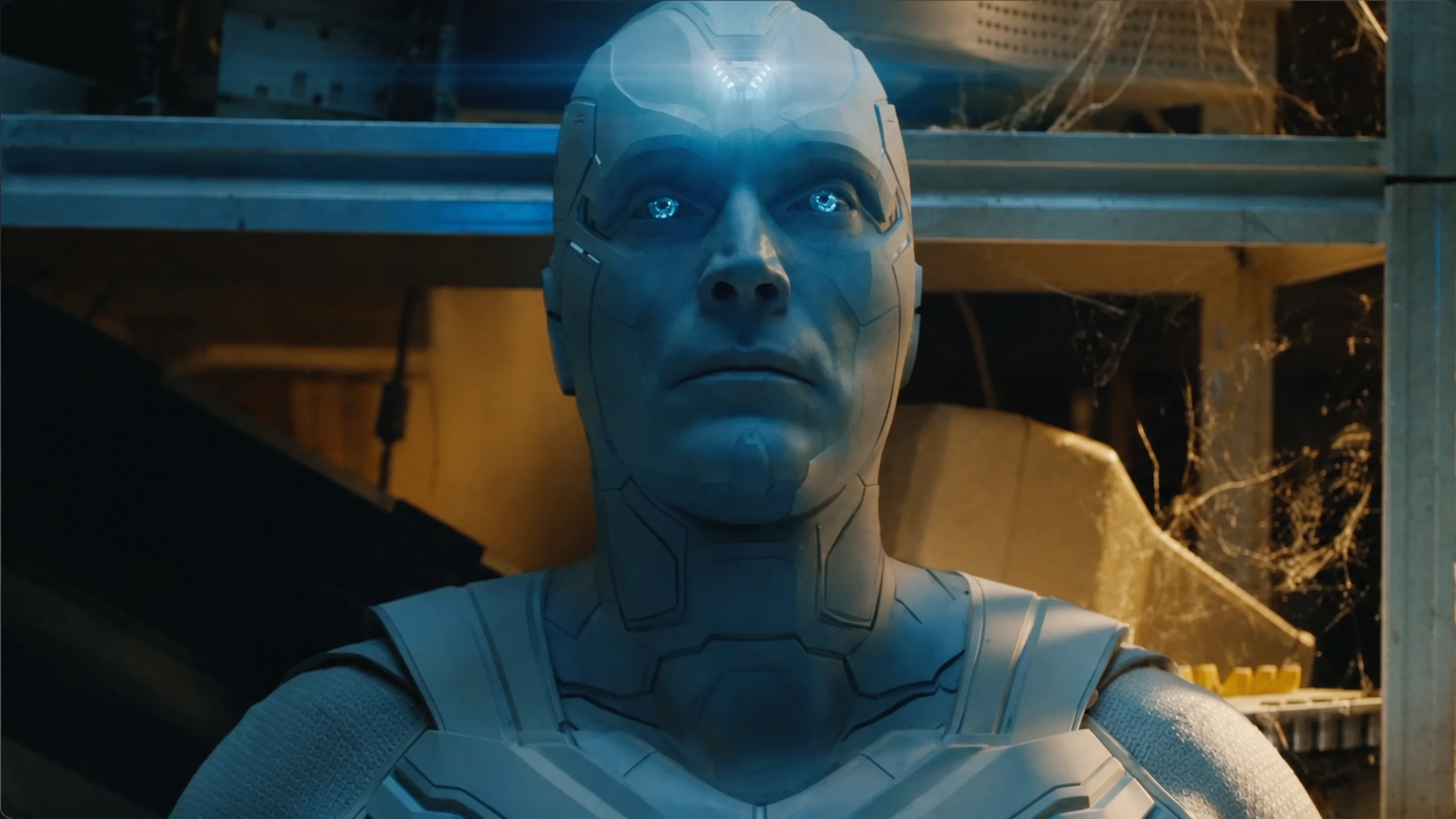 Paul Bettany as White Vision inside a damaged workshop in VisionQuest.
