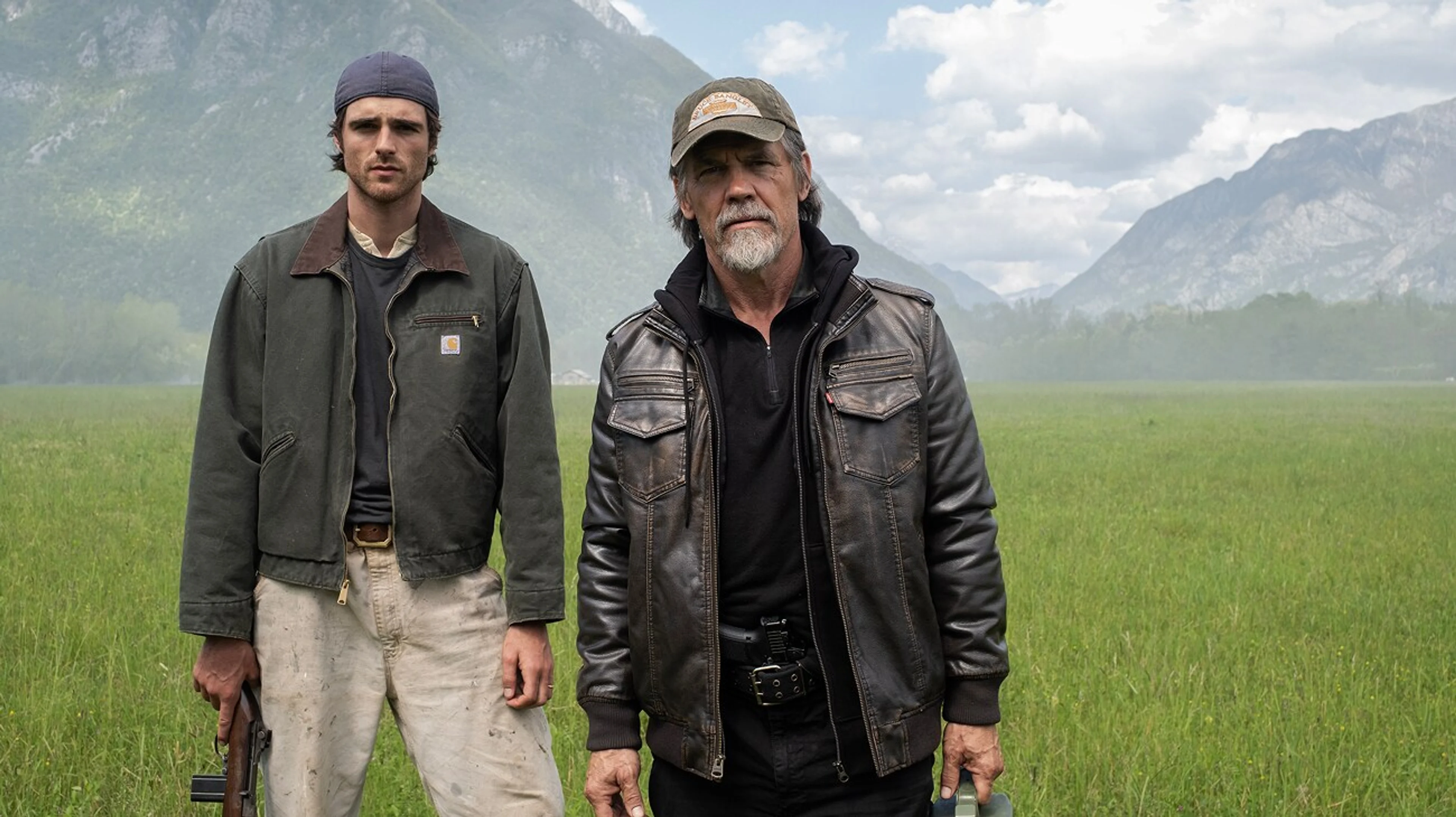 Jacob Elordi as Hig and Josh Brolin as Bangley stand in a mountain field in The Dog Stars.