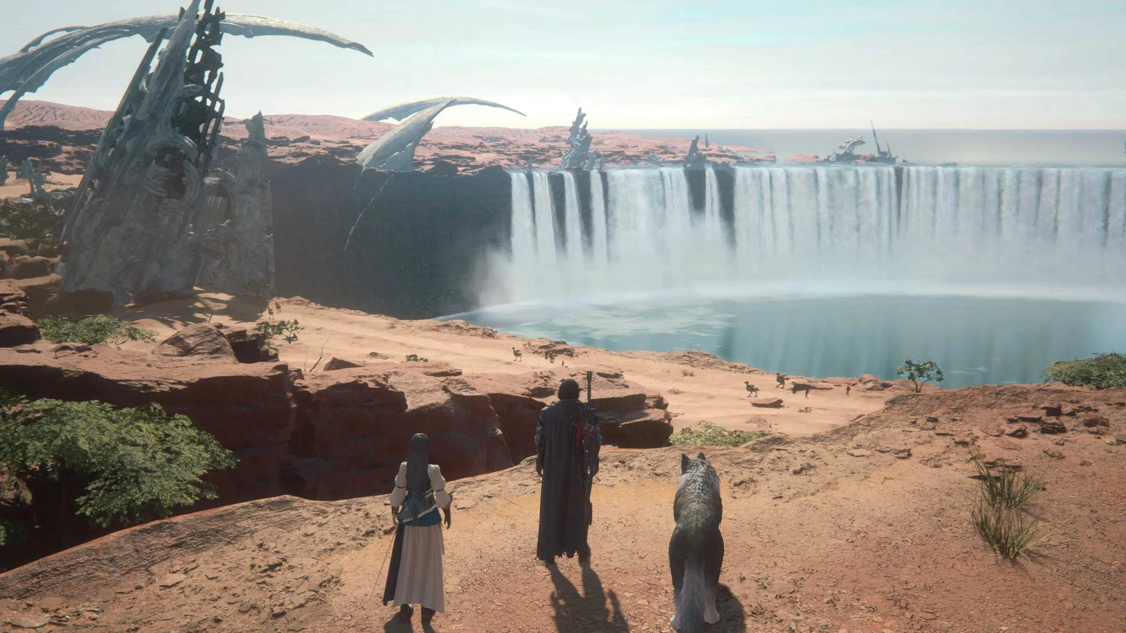 Clive, Jill, and Torgal look across a dry Valisthea landscape divided by a massive waterfall.