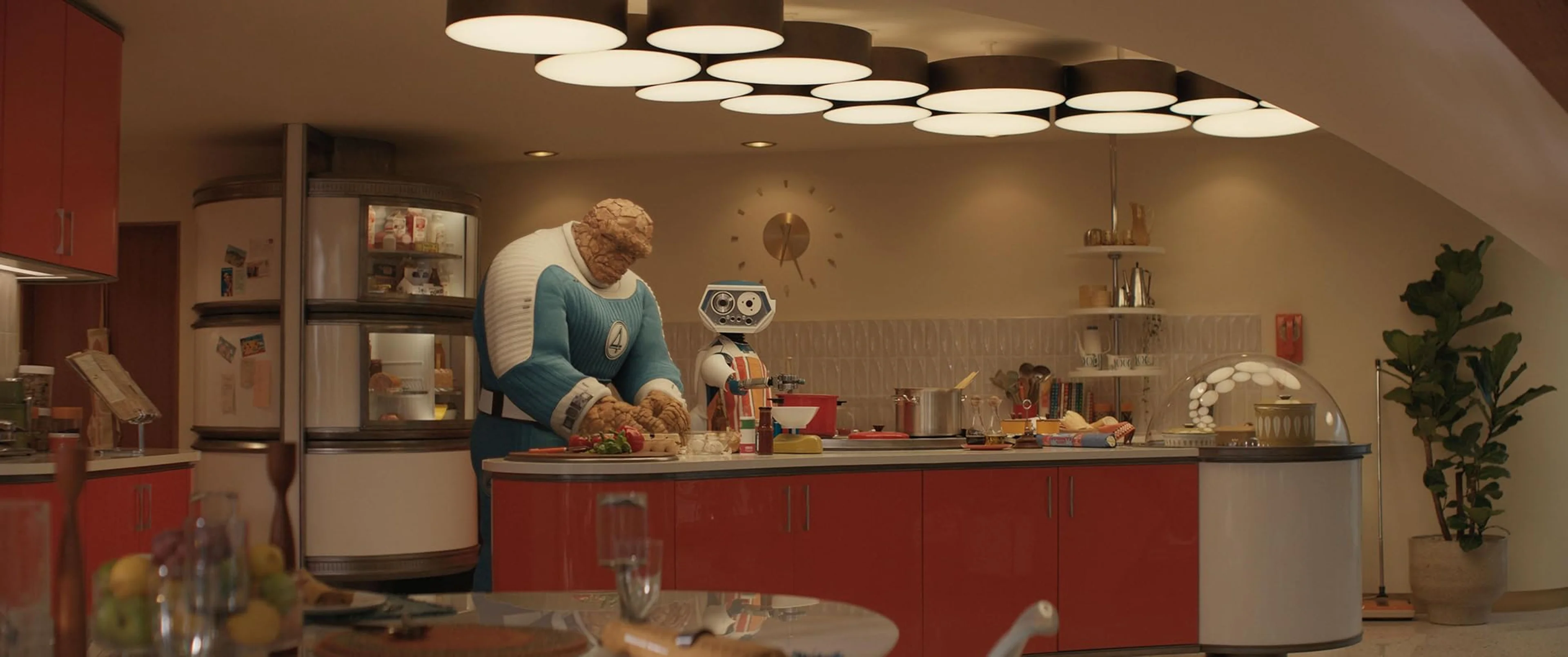 Ben Grimm prepares food while H.E.R.B.I.E. helps in the Baxter Building kitchen.