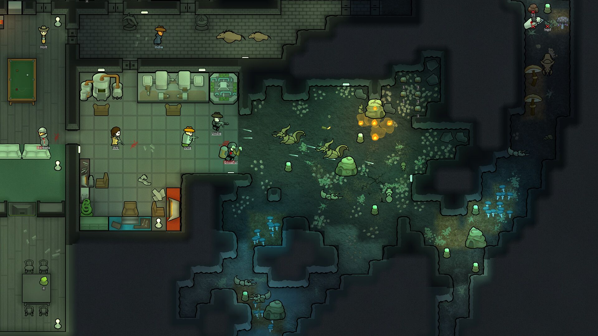 A small colony is built into a rocky green hillside with rooms and a growing area.