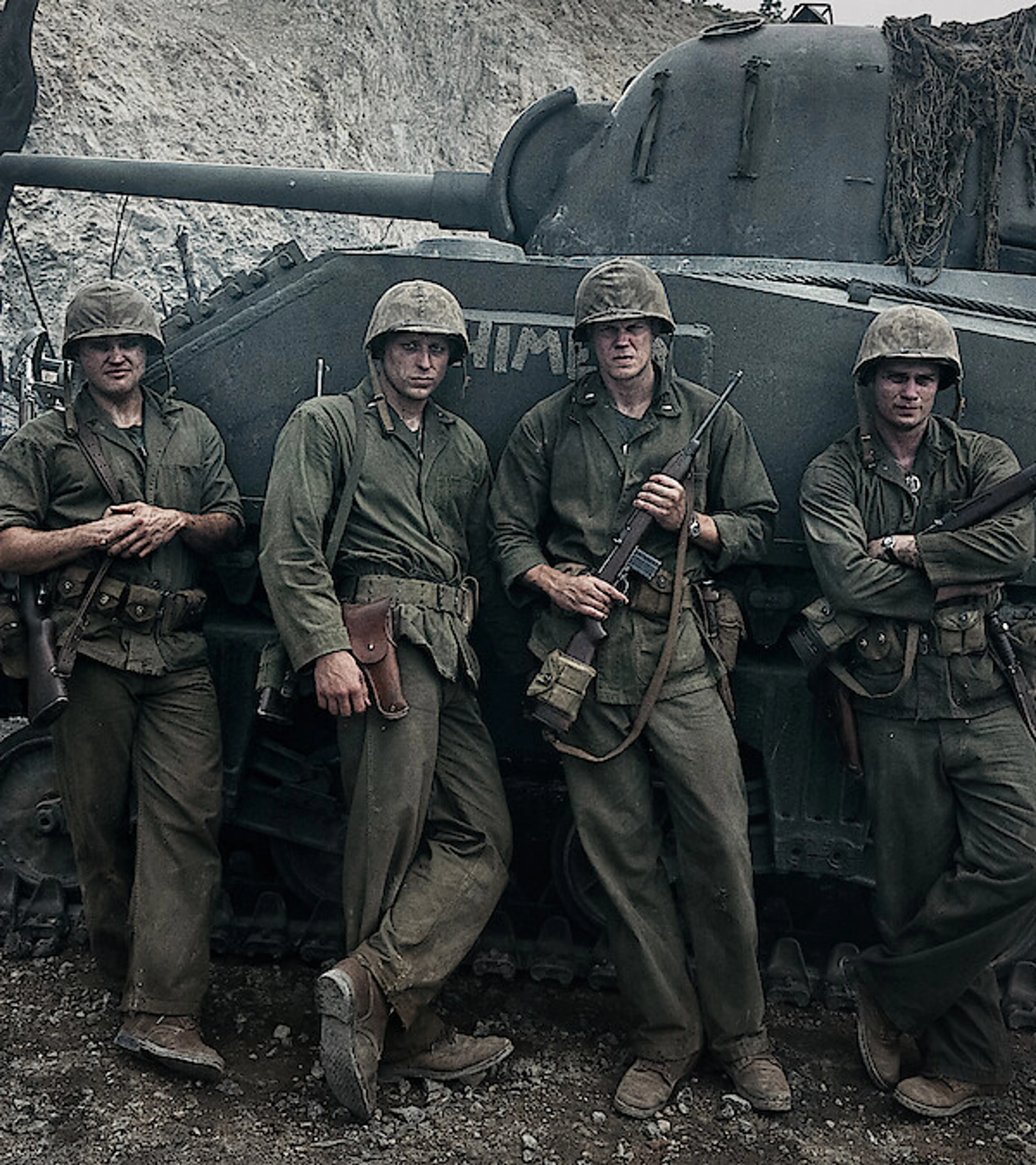 Nicholas Galitzine, Bill Skarsgård, Ray Nicholson and Tom Francis stand in Marine uniforms beside a tank in The Mosquito Bowl.