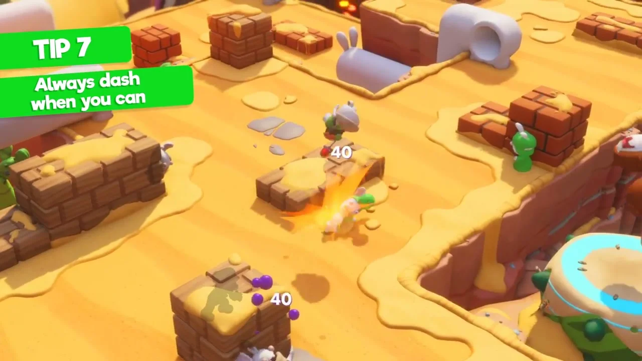 Ubisoft tutorial shows a hero dashing through an enemy on a sandy turn-based battlefield.